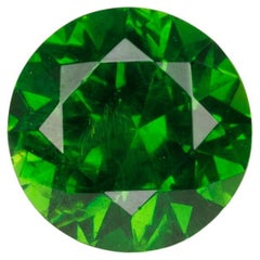 Faceted vivid green Rusisan demantoid garnet with horsetail inclusion, 0.52cts