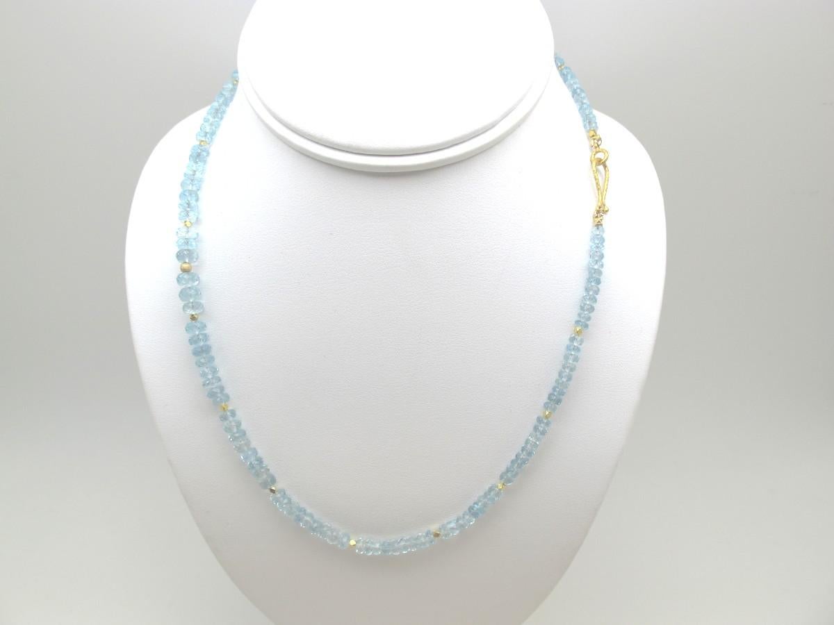 This pretty 18-inch necklace features beautiful aquamarine beads that have been faceted into sparkling rondelles and hand strung for a look of sheer elegance! The beads have a heavenly sky blue color and are accented with bright 18k and 22k yellow