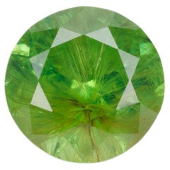 Facted demantoid garnet with obvious horsetail inclusion, 0.7 ct