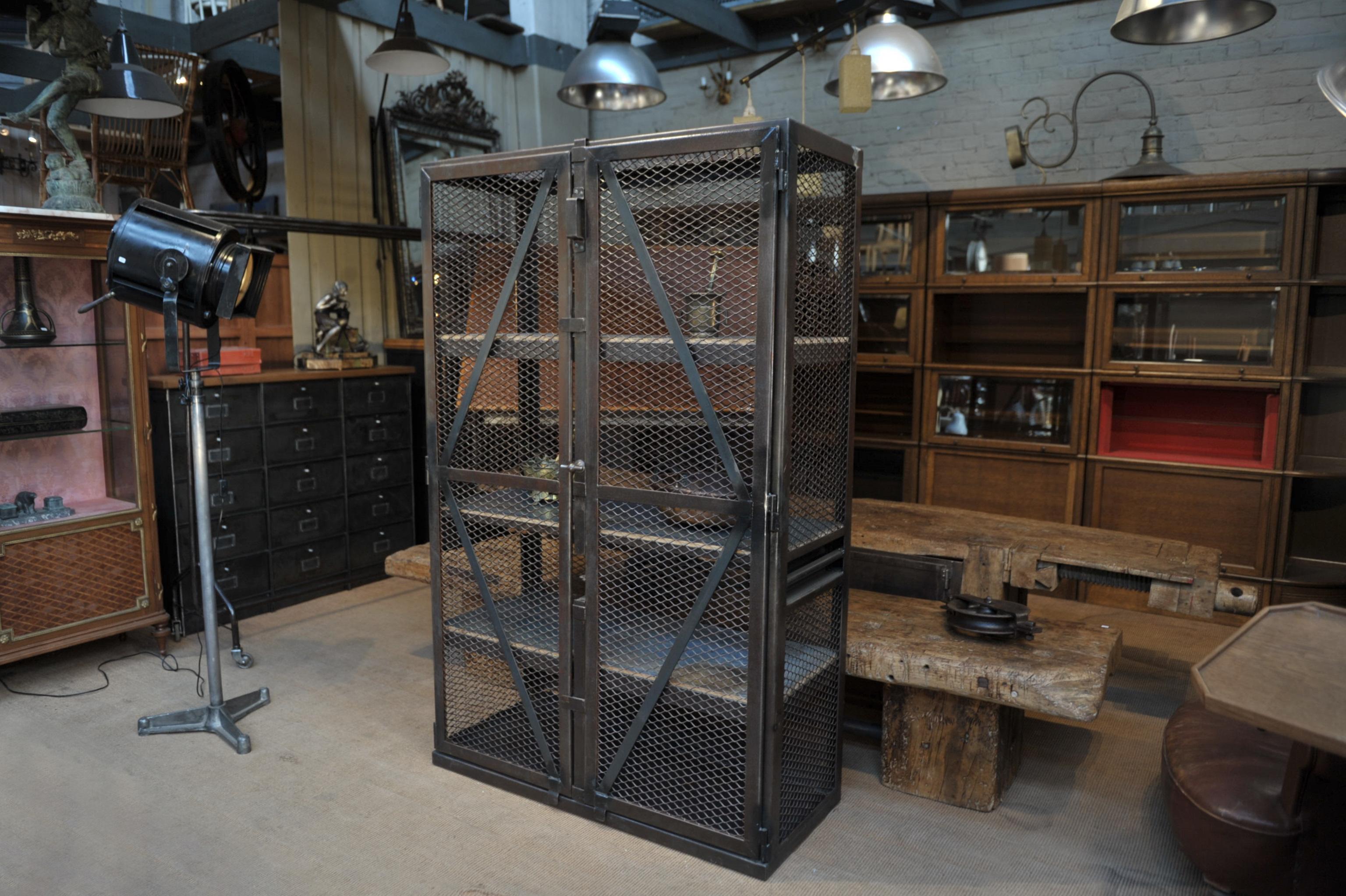 2 doors opening perfectly Industrial mesh iron factory bookcase cabinet with 3 original grey patina solid oak shelves inside, Circa 1950 all hand polish finish very good condition.