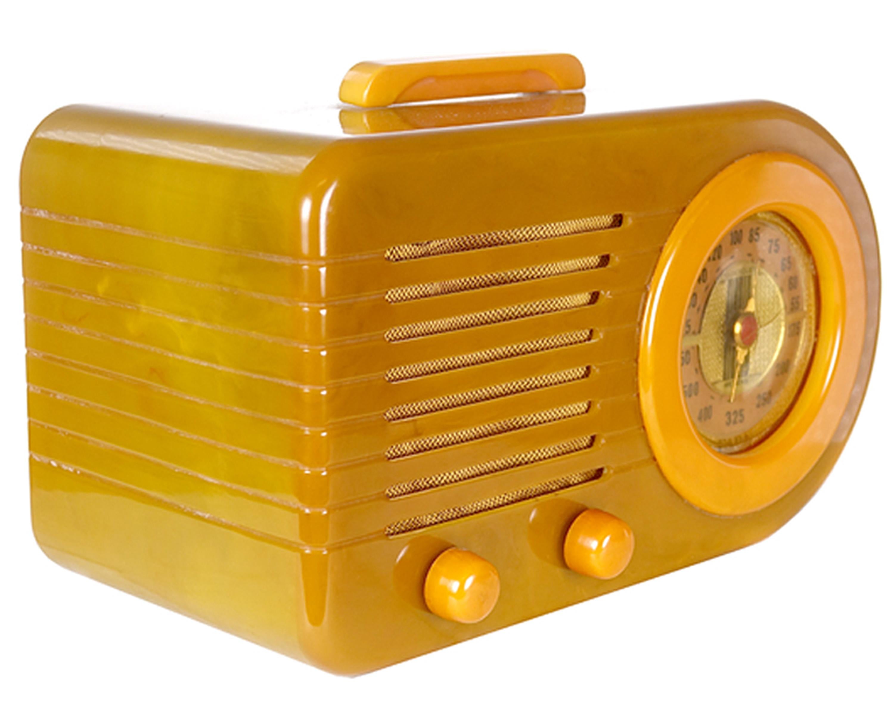 Iconic FADA 'Bullet' Model 1000 in a rare Onyx with Butterscotch Catalin - beautiful + original Art Deco radio. This radio styling epitomizes 1940's Streamline design with its sleek rounded lines that suggest speed and practicality, hallmarks of