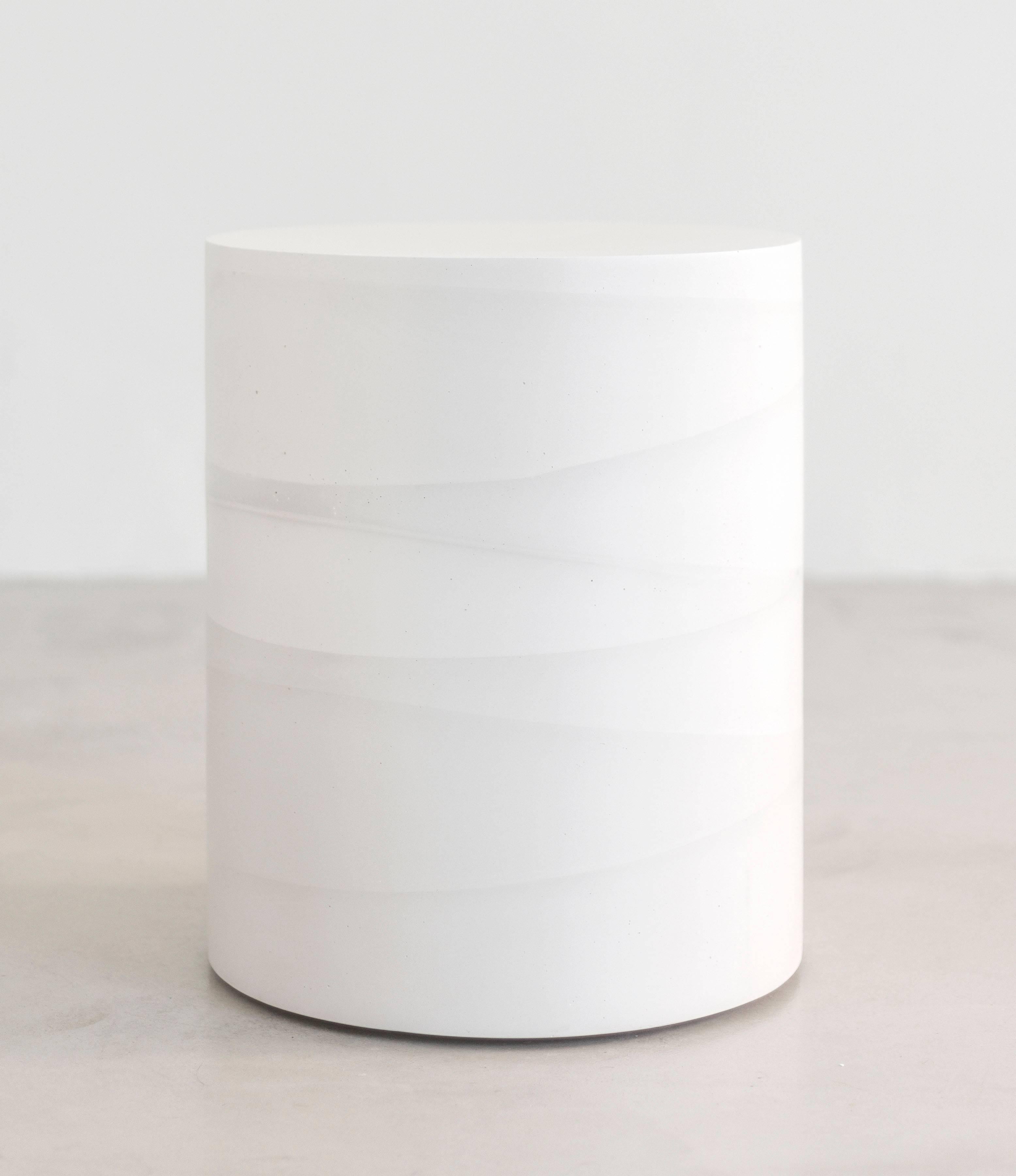 An exploration in the softness and subtly of the materials, the made-to-order drum has a hollow cavity and is cast entirely from hand-dyed cement. Poured in individual hand-dyed layers of white cement, the simple geometric form creates a light ombre