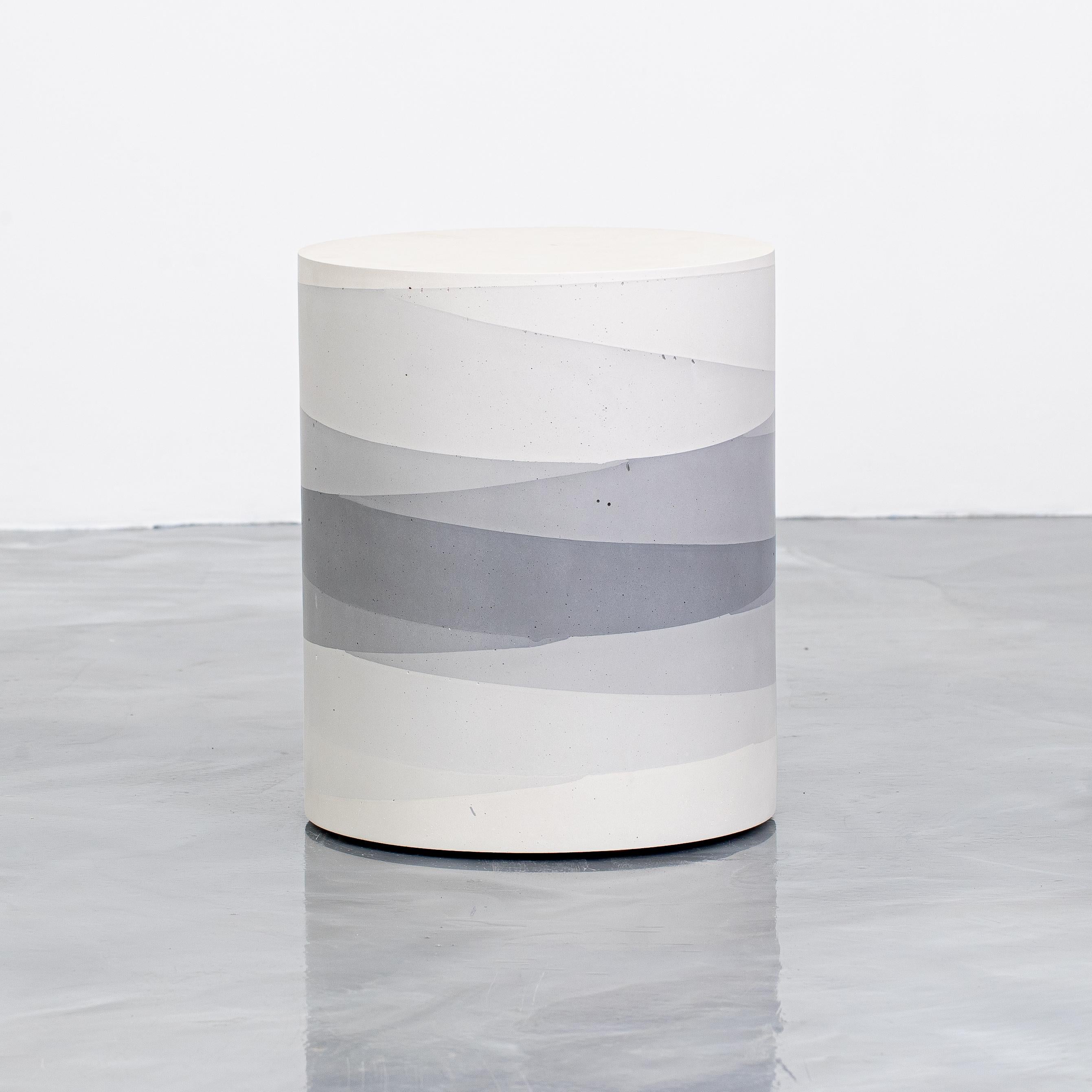 An exploration in the softness and subtly of the materials, the made-to-order drum has a hollow cavity and is cast entirely from hand-dyed cement. Poured in individual hand-dyed layers, starting from the base color grey and fading to white, the