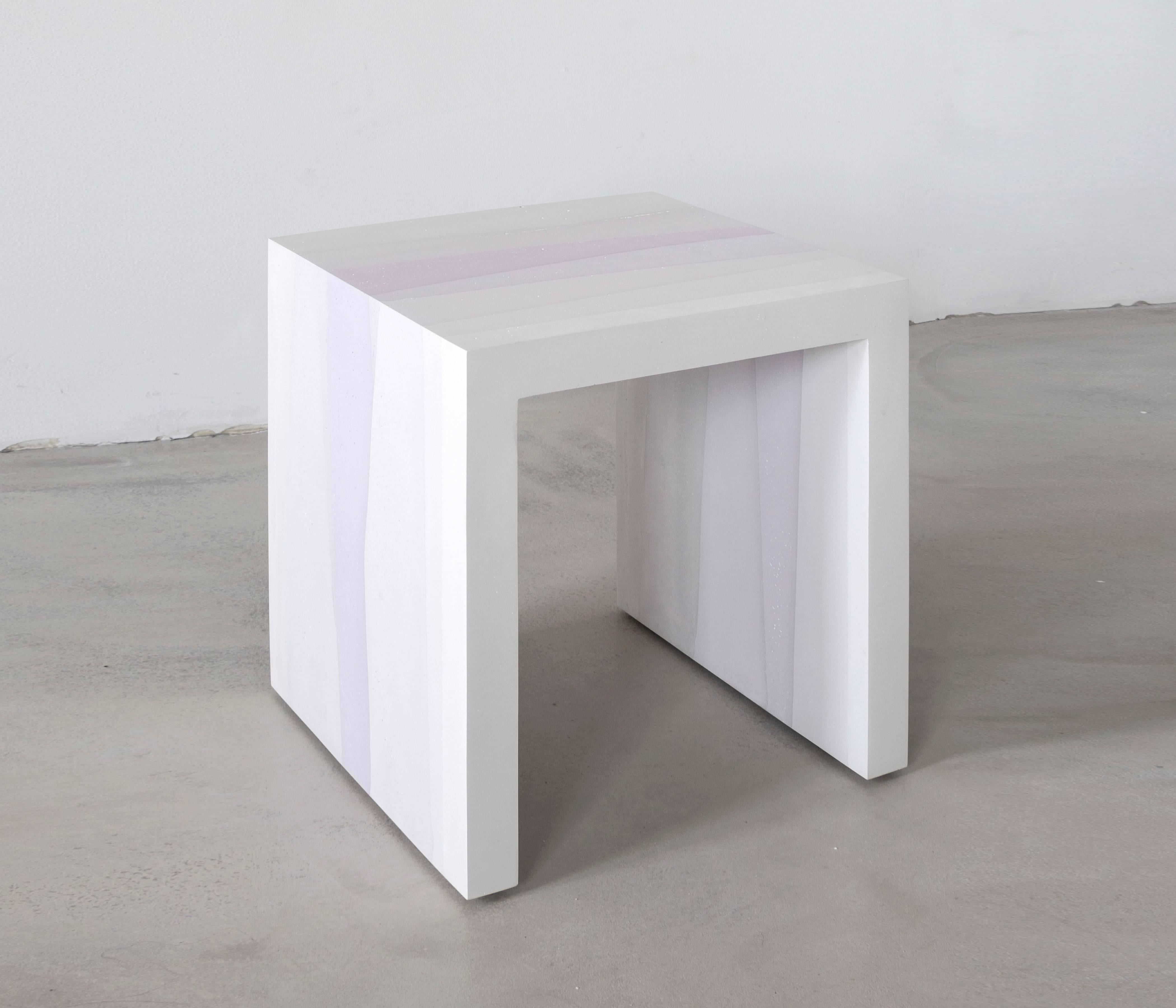 A contrast of softness and sharp angles, the made-to-order side table is cast entirely from hand-dyed cement. Poured in layers, the simple geometric form creates a light ombre effect reminiscent of watercolor. The piece weighs approximately 65lbs.