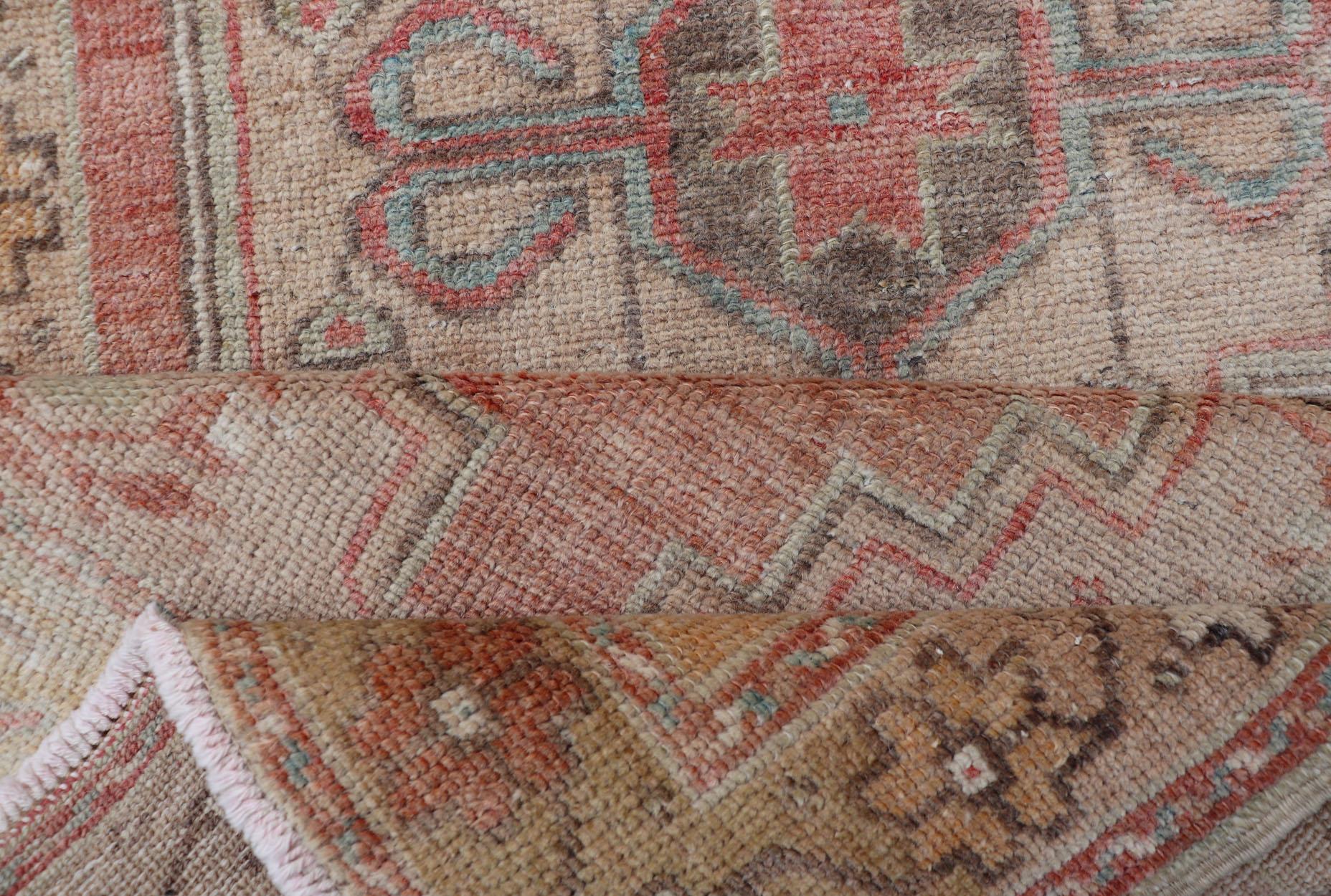 Wool Faded Coral and Taupe Vintage Turkish Oushak Rug with Layered Medallion Design For Sale