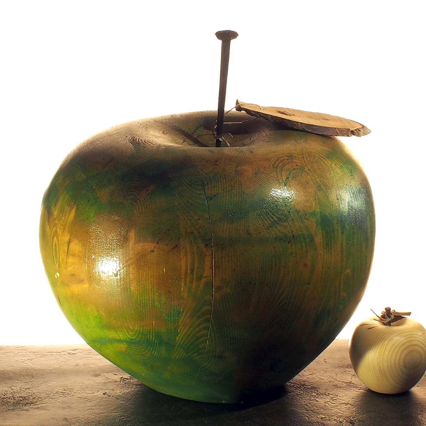 This glossy green apple is a unique creation made completely by hand by Pietro Arnoldi and was sculpted from a piece of solid fir wood. Using a chain saw, the artist crafted the apple, which was sanded down and painted green. Further sanding gives