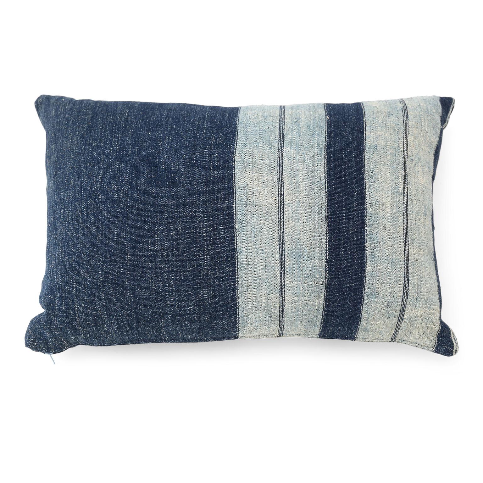 Faded indigo cushions made from antique handwoven slubby cotton fabric. Cushions include zip fasteners and feather inserts. Two available. Sold separately and priced $480 each.