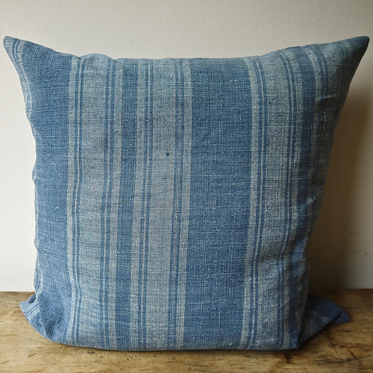 19th century French beautifully faded indigo striped cushion in a soft woven linen, a beautiful and hard to find textile. Self-backed and slip-stitched closed with a duck feather insert.
 