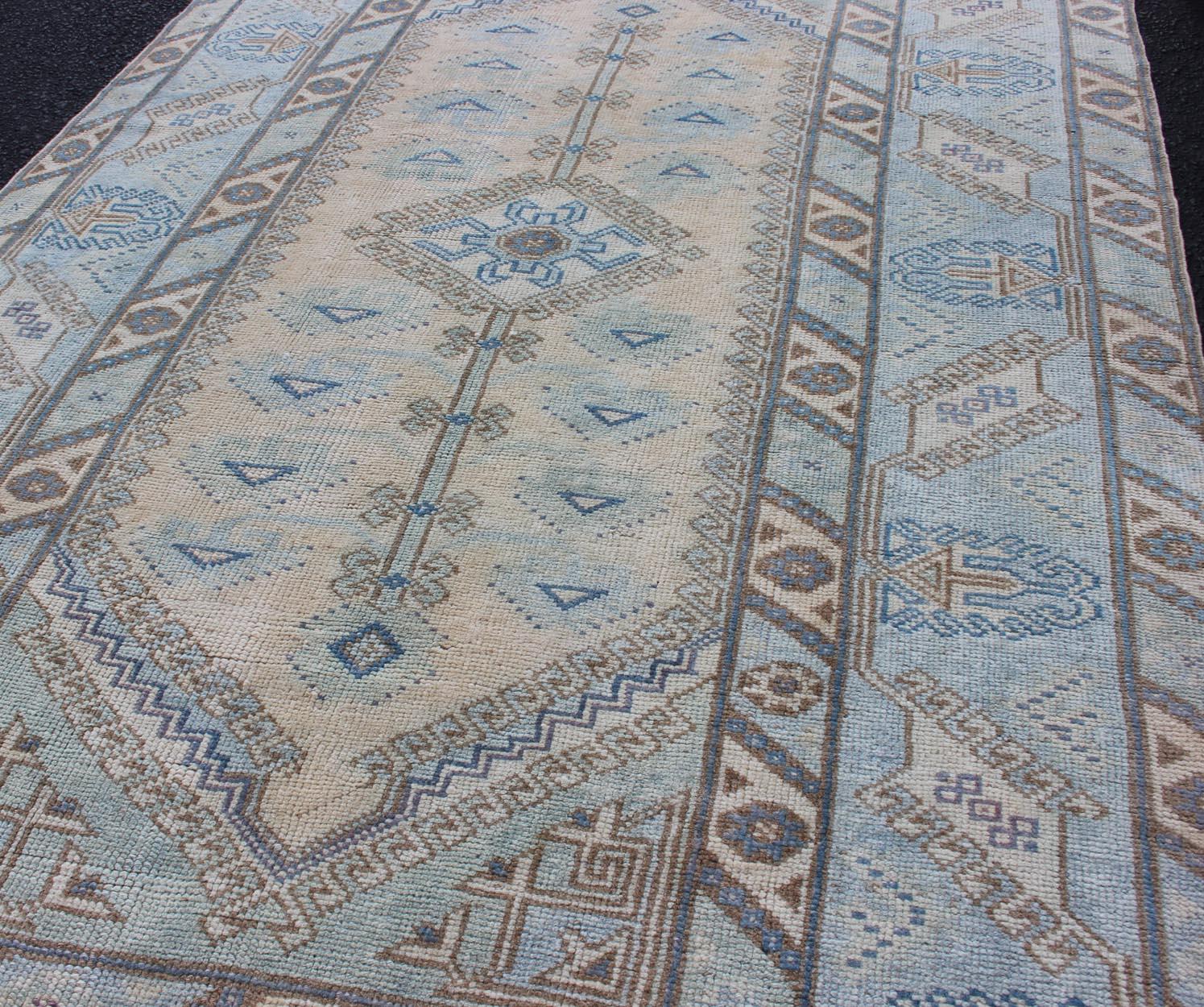 Hand-Knotted Faded Oushak Rug from Turkey with All Over Design in Blues and Cream For Sale
