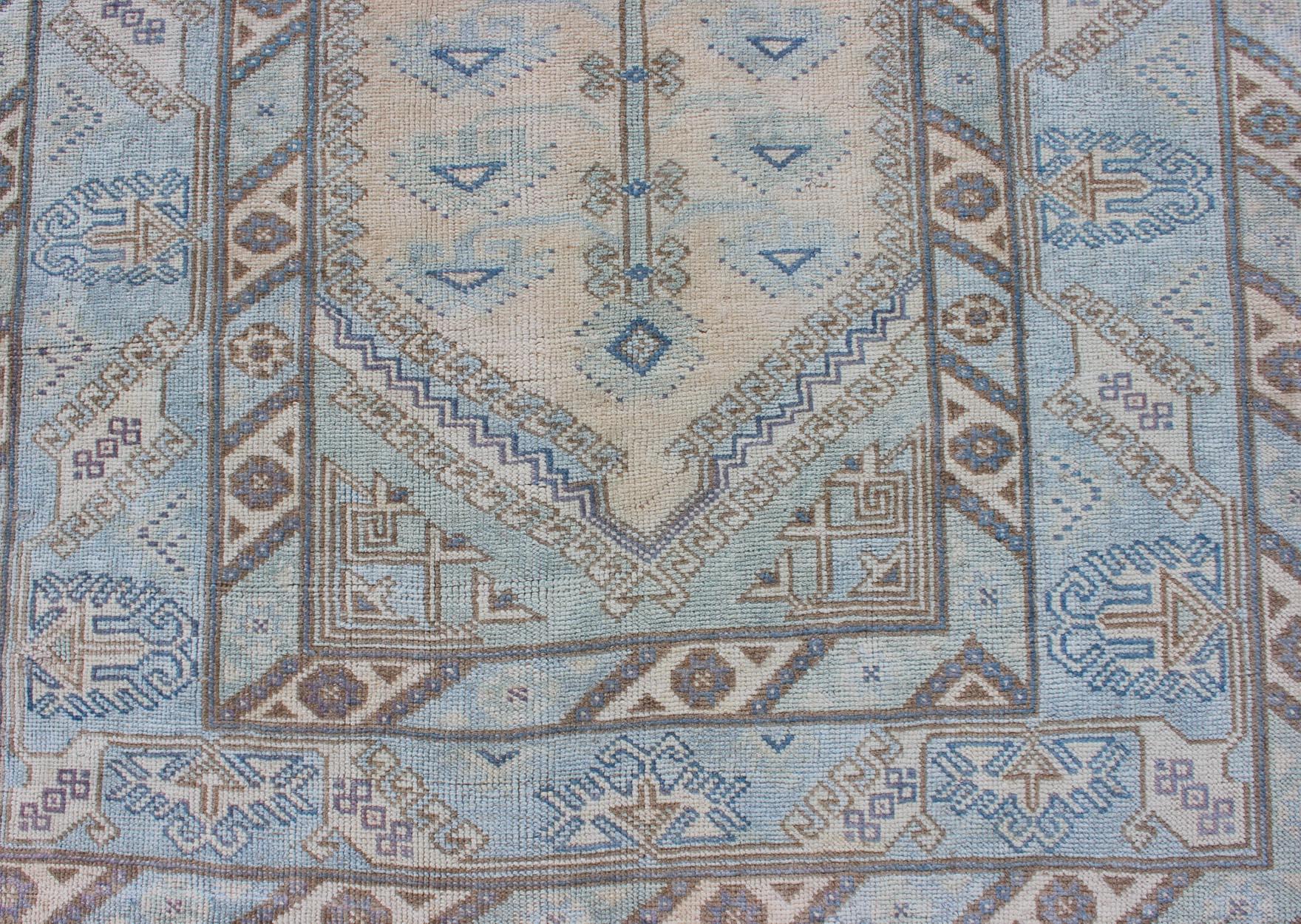 20th Century Faded Oushak Rug from Turkey with All Over Design in Blues and Cream For Sale