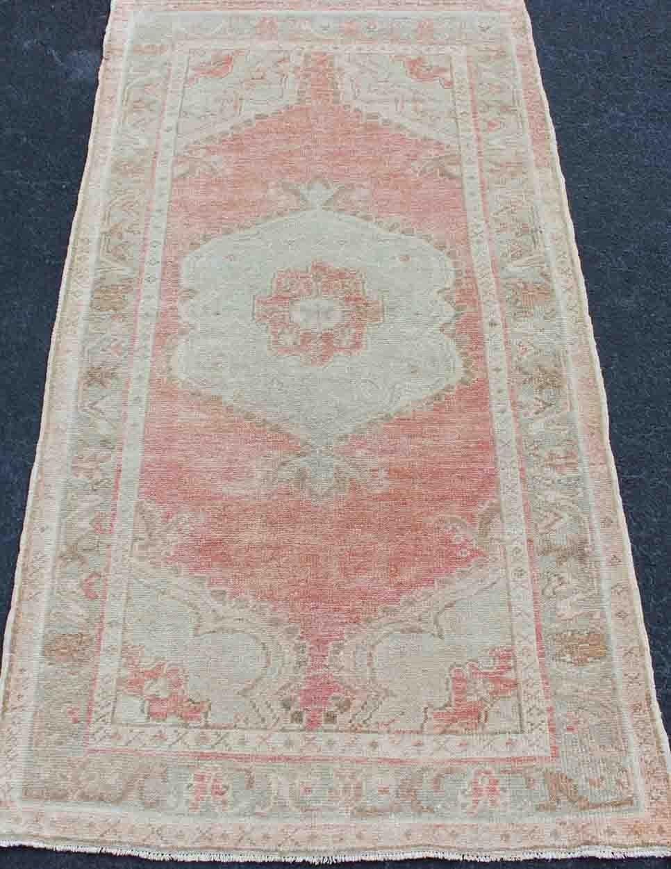 20th Century Faded Red and Taupe Vintage Turkish Oushak Rug with Layered Medallion Design For Sale