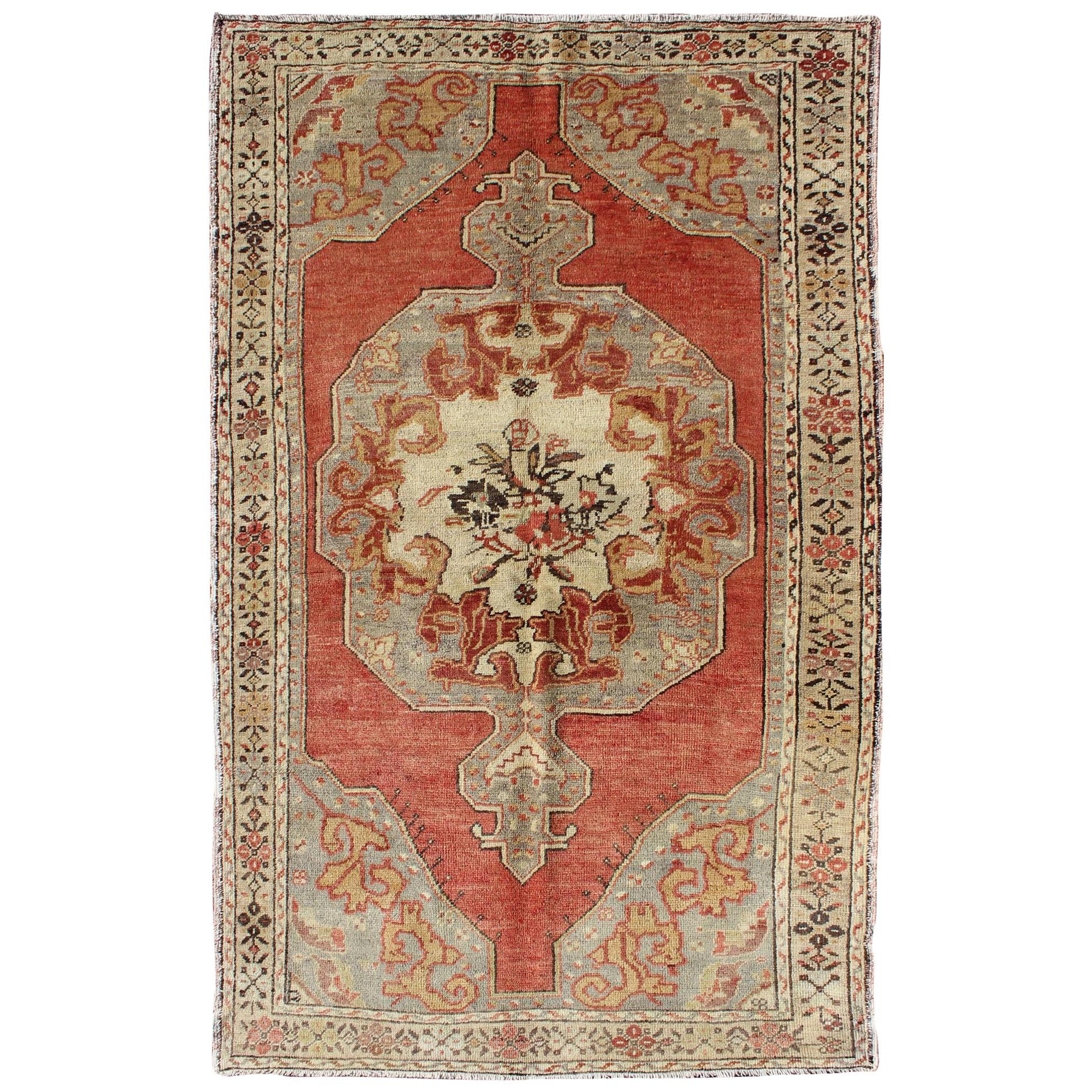 Faded Red and Taupe Vintage Turkish Oushak Rug with Layered Medallion Design For Sale