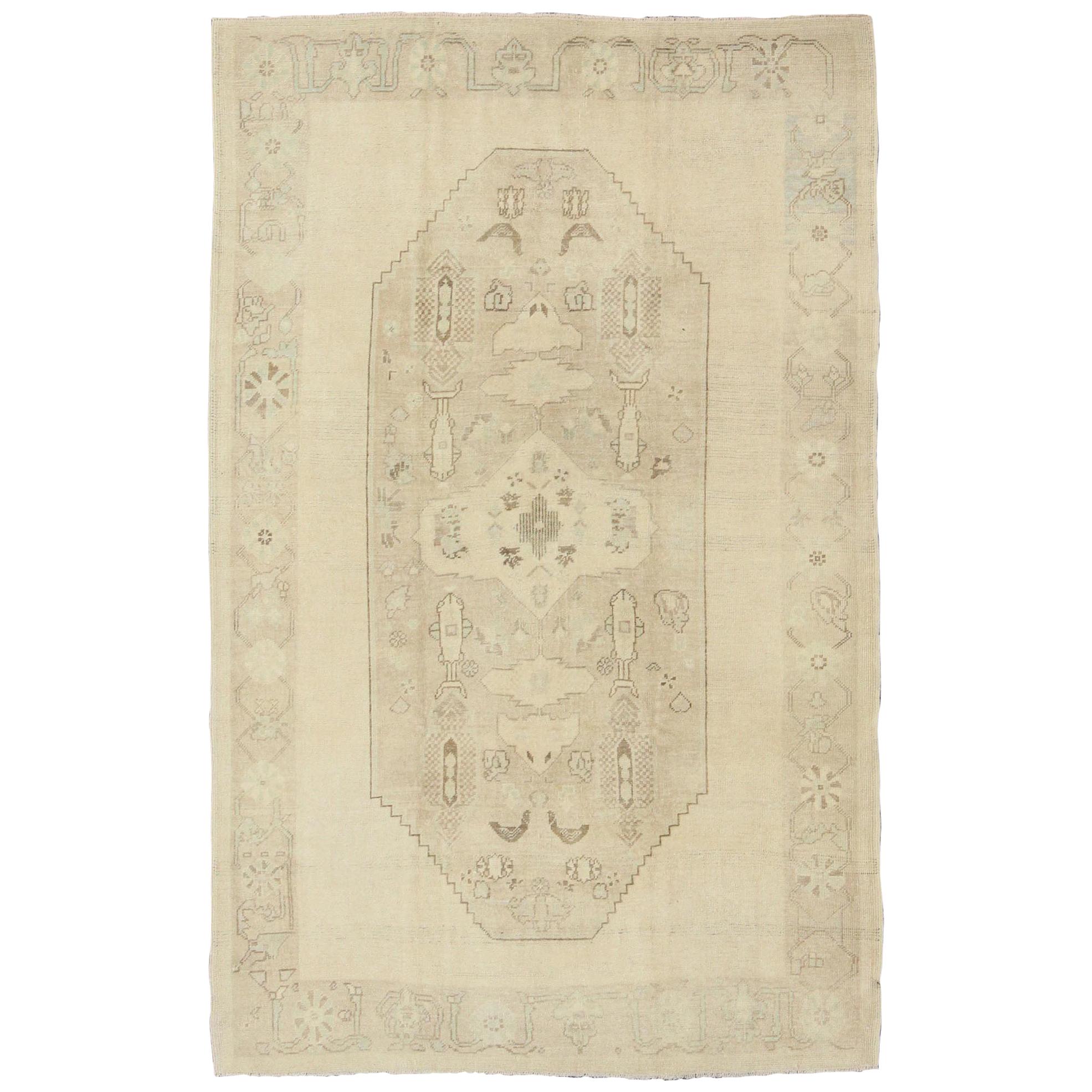 Faded Turkish Oushak Rug with Central Medallion Design in Cream and Brown