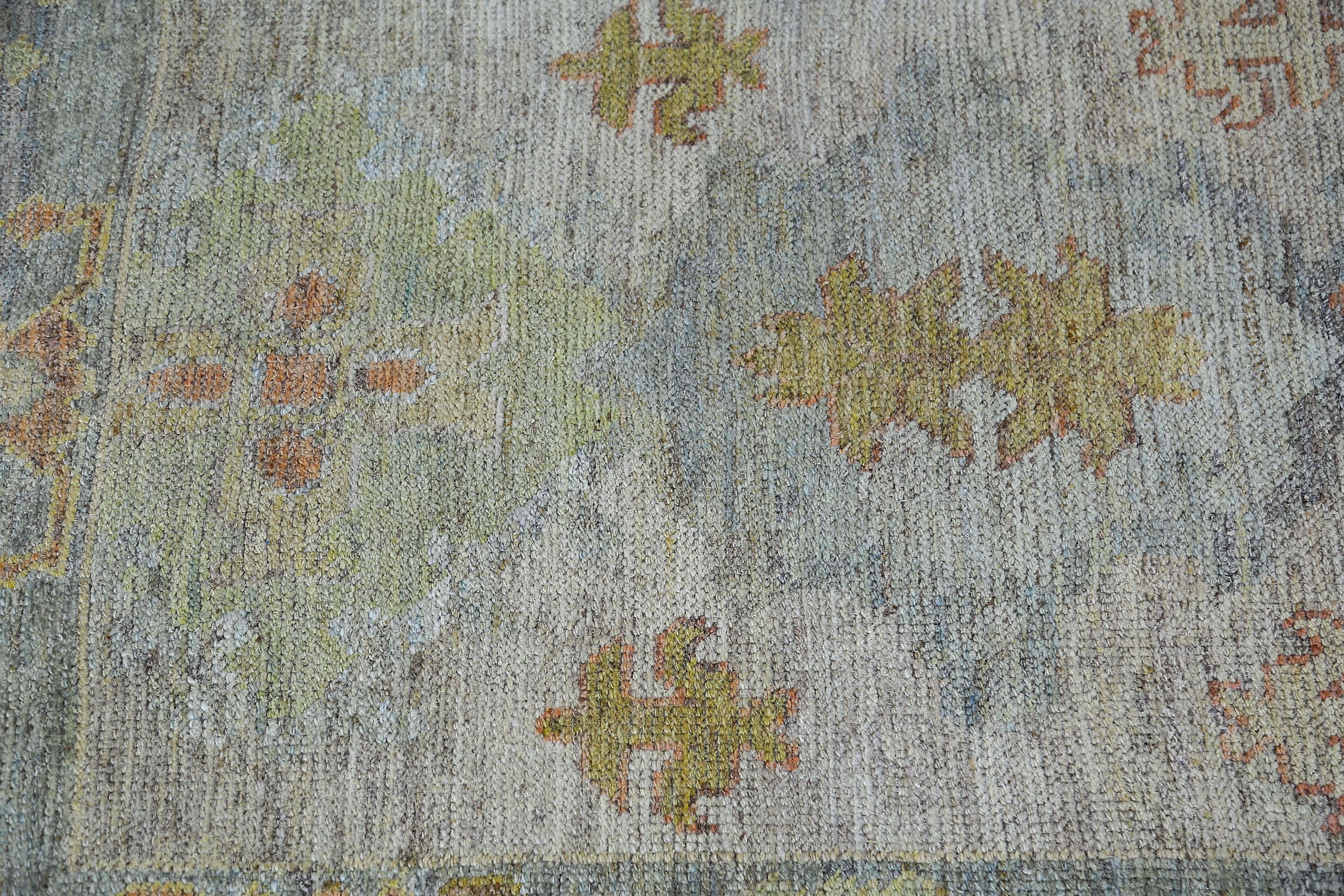 Introducing our exquisite Turkish Oushak rug in a size of 3'3'' x 10'0'', perfect for adding a touch of sophistication to any hallway or narrow space. This rug features a stunning faded blue color palette with no pops of color, giving it a vintage