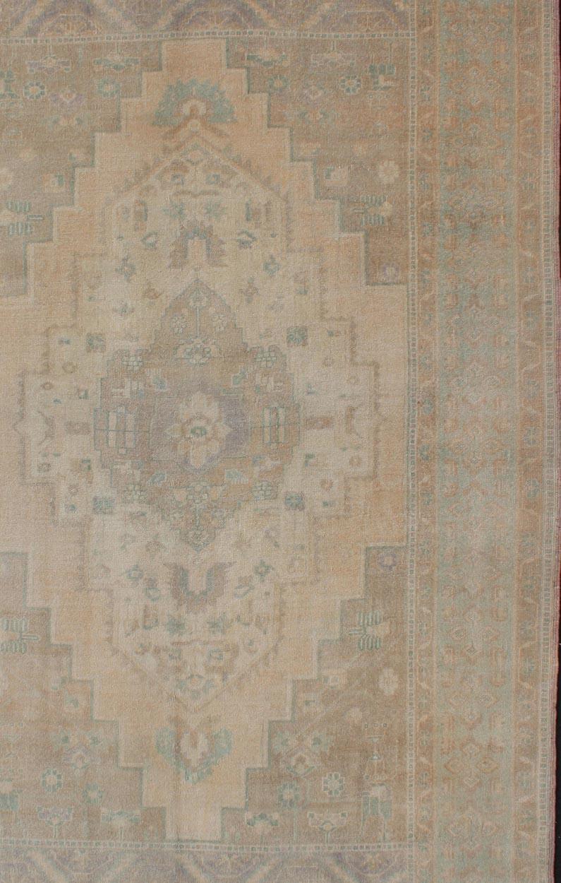 Hand-Knotted Faded Turkish Oushak with Medallion with Muted Colors of Tan, Muted Light Peach For Sale