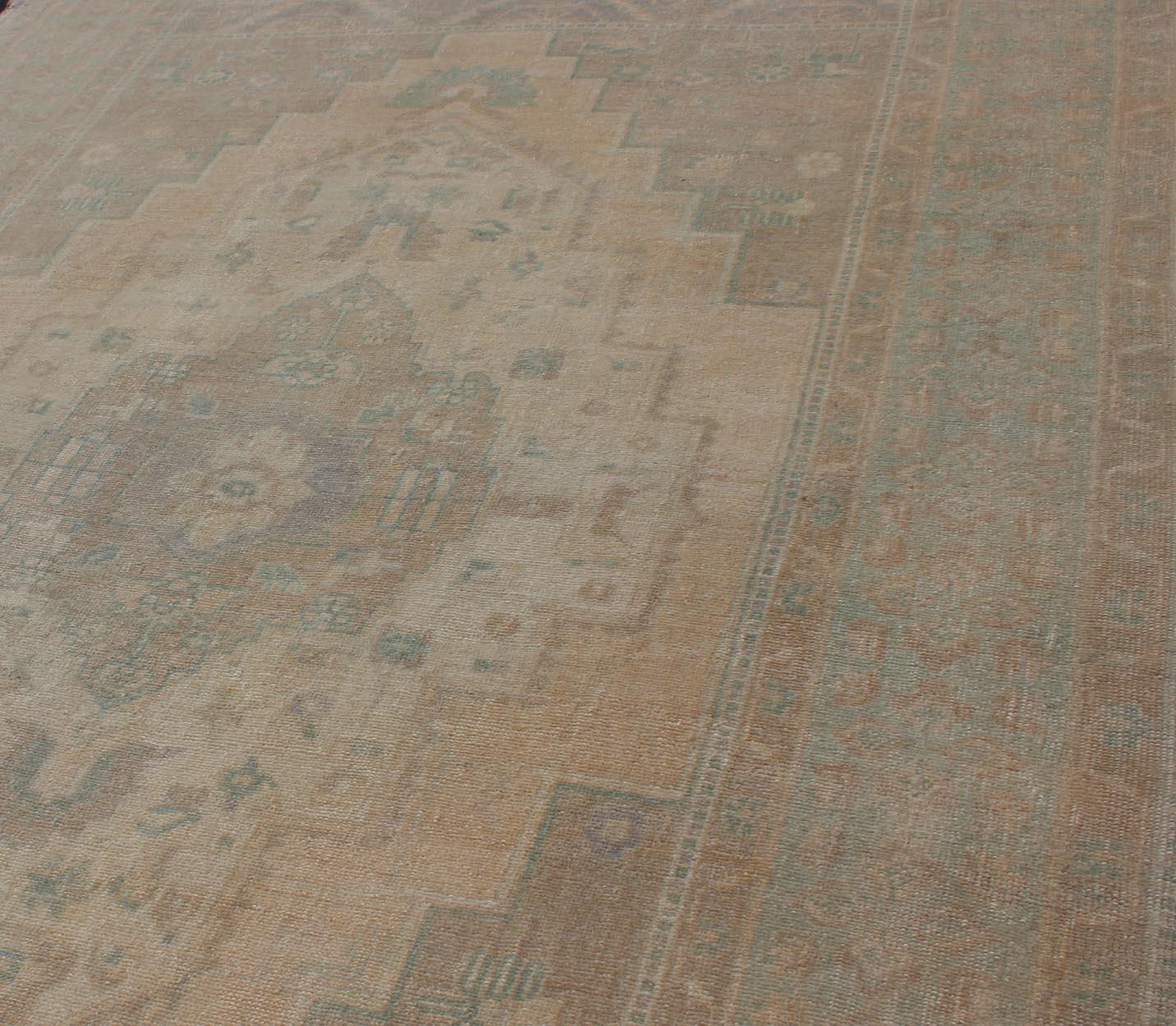 Wool Faded Turkish Oushak with Medallion with Muted Colors of Tan, Muted Light Peach For Sale