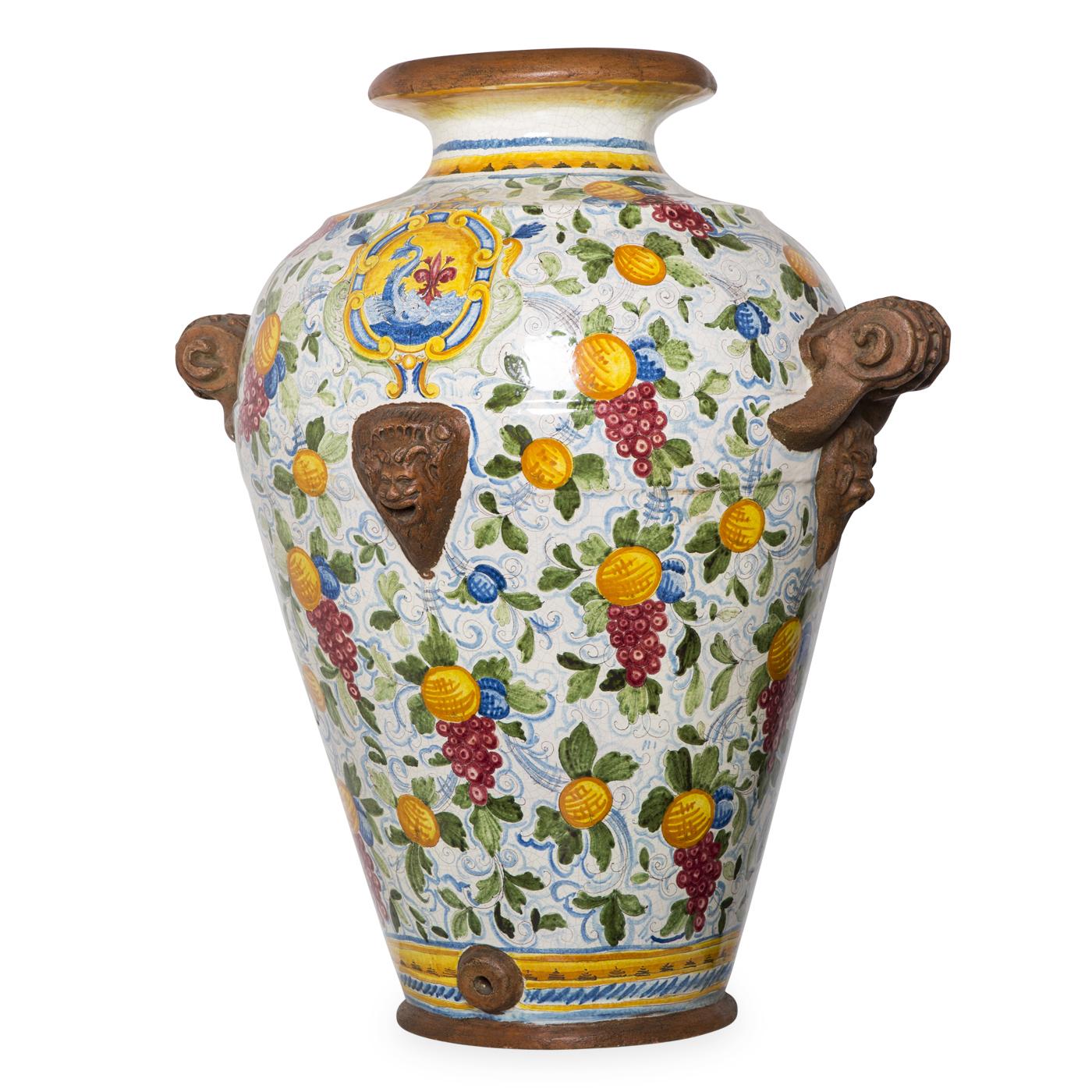 Faenza has since long been a major center for ceramics in Italy. This splendid large ceramic jar follows the town's typical style, with an original floral and fruit design in characteristic antimony yellow and yellow ochre. The vase is meticulously