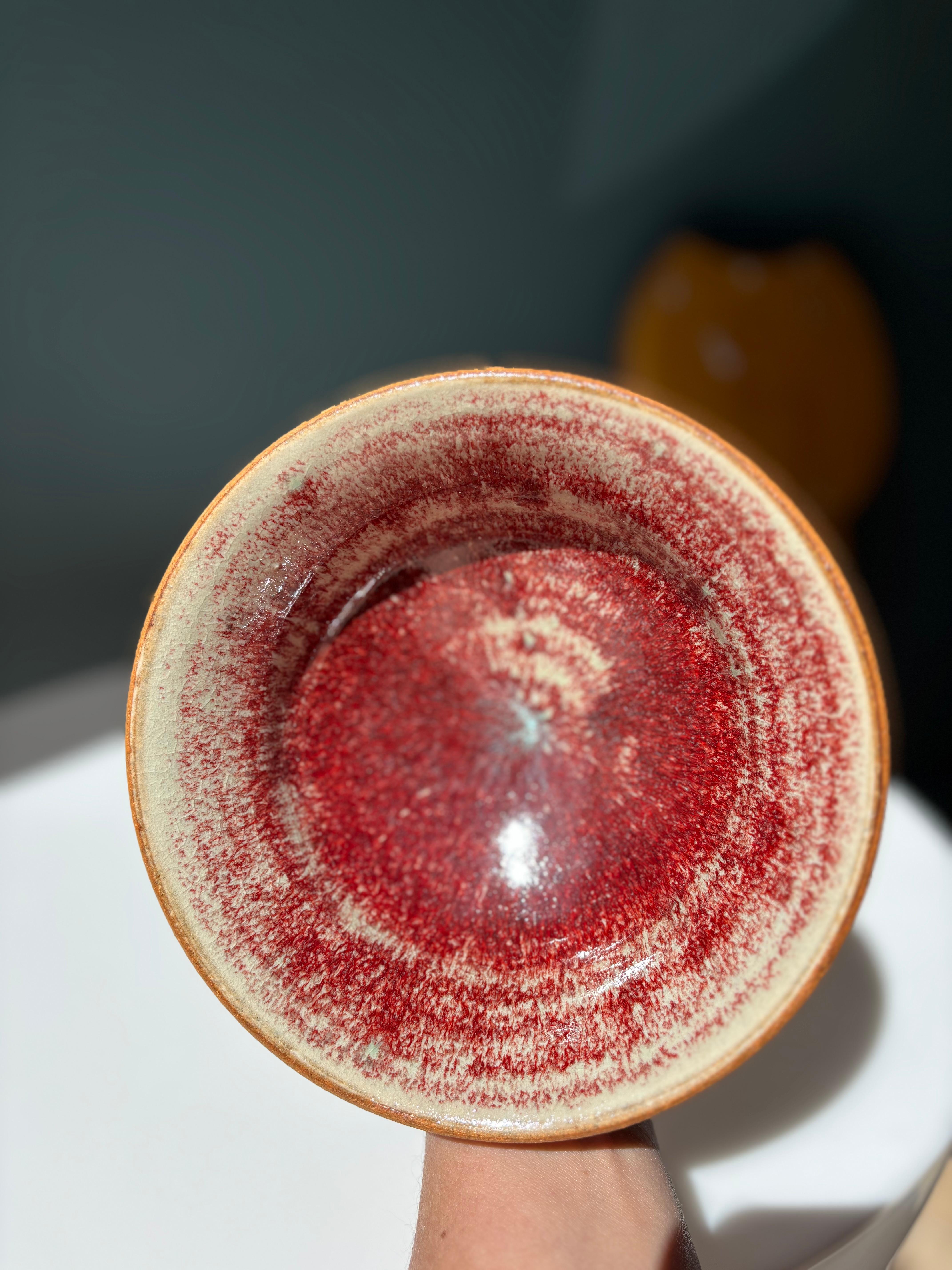 Vintage studio ceramic decorative bowl by Swedish designer Janne Fagerfäldt in the 1970s. The handthrown bowl has an unglazed exterior and beautiful shiny ox blood glaze with a turquoise tint on the inside. No signs of use or wear. Signed under