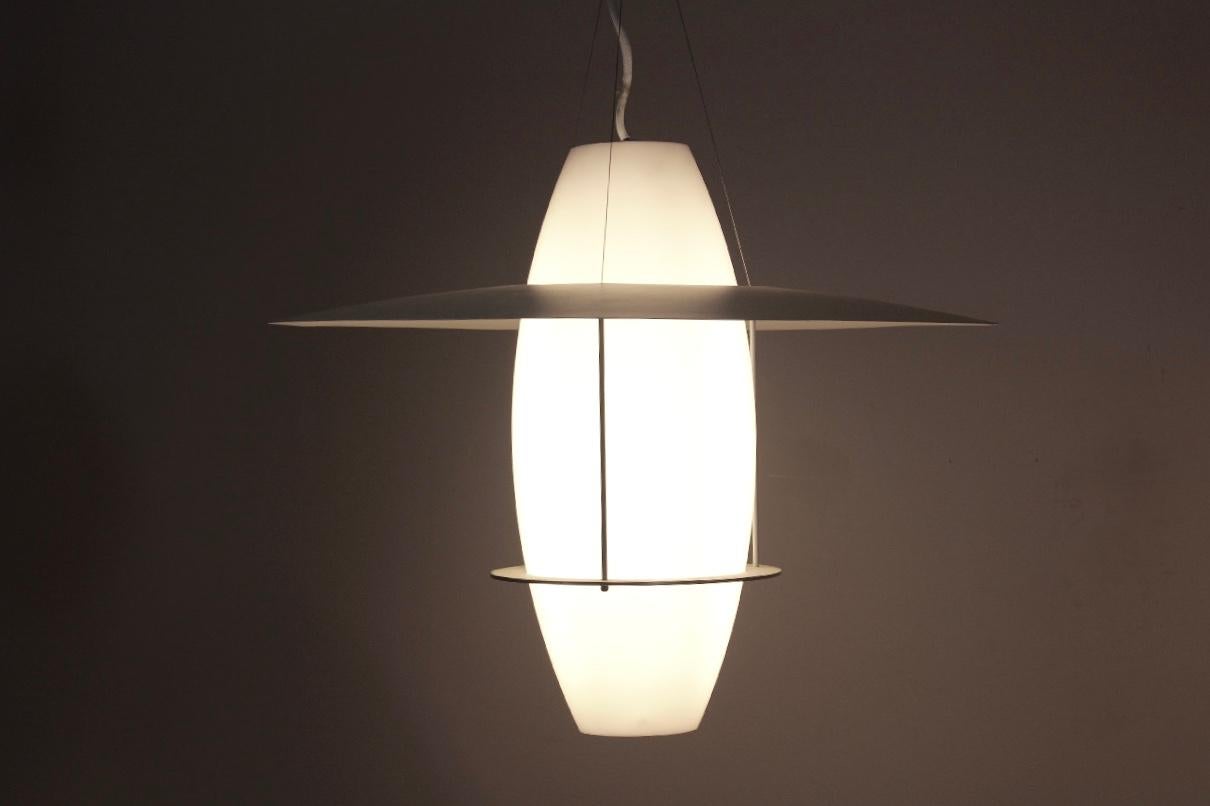 Very beautiful and fascinating Sonatra pendant designed by Jan Wickelgren and manufactured by Fagerhult in 2006 in Sweden. This iconic example of Scandinavian design features an Opal strucrylic diffuser with two enameled steel rings around it