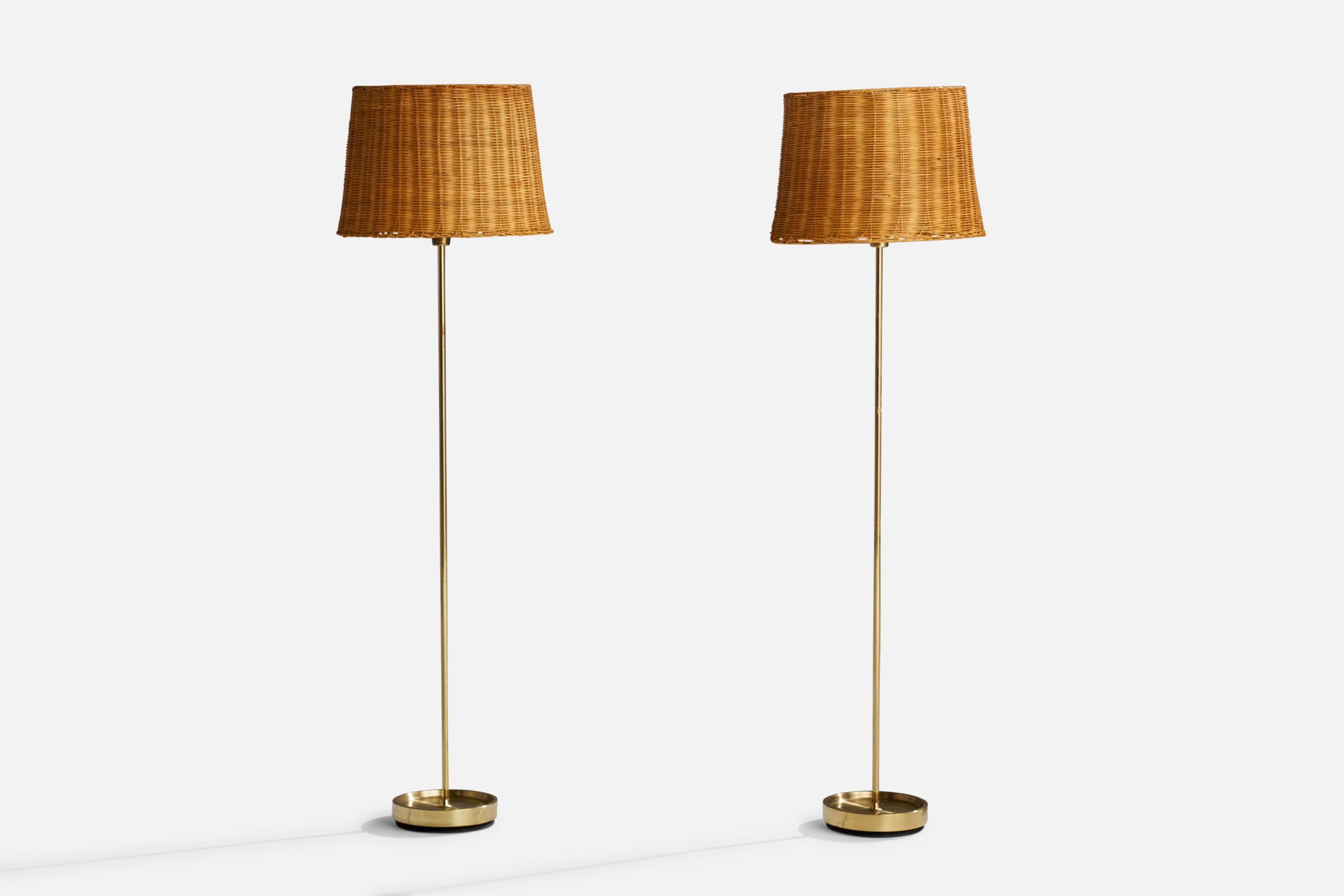 A pair of brass and rattan floor lamps designed and produced by Fagerhults Belysning, Sweden, 1960s.

Overall Dimensions (inches): 57.5”  H x 16” W x 17.5” D
Stated dimensions include shade.
Bulb Specifications: E-26 Bulb
Number of Sockets: 2
All