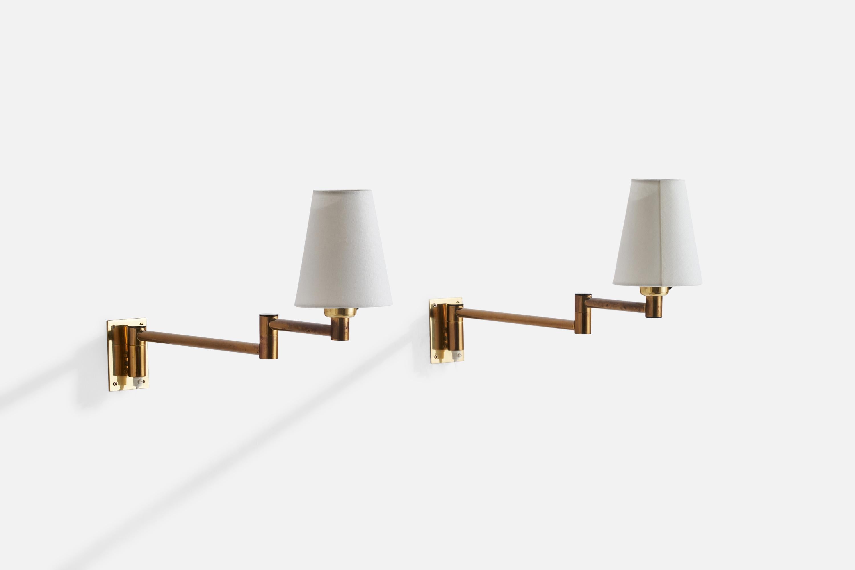 A pair of adjustable brass, plastic and white fabric wall lights designed and produced by Fagerhults Belysning, Sweden, 1980s.

Overall Dimensions (inches): 8”  H x 11.5”  W x 18” D
Back Plate Dimensions (inches): 4”  H x 2.75”  W x .25”  D
Bulb