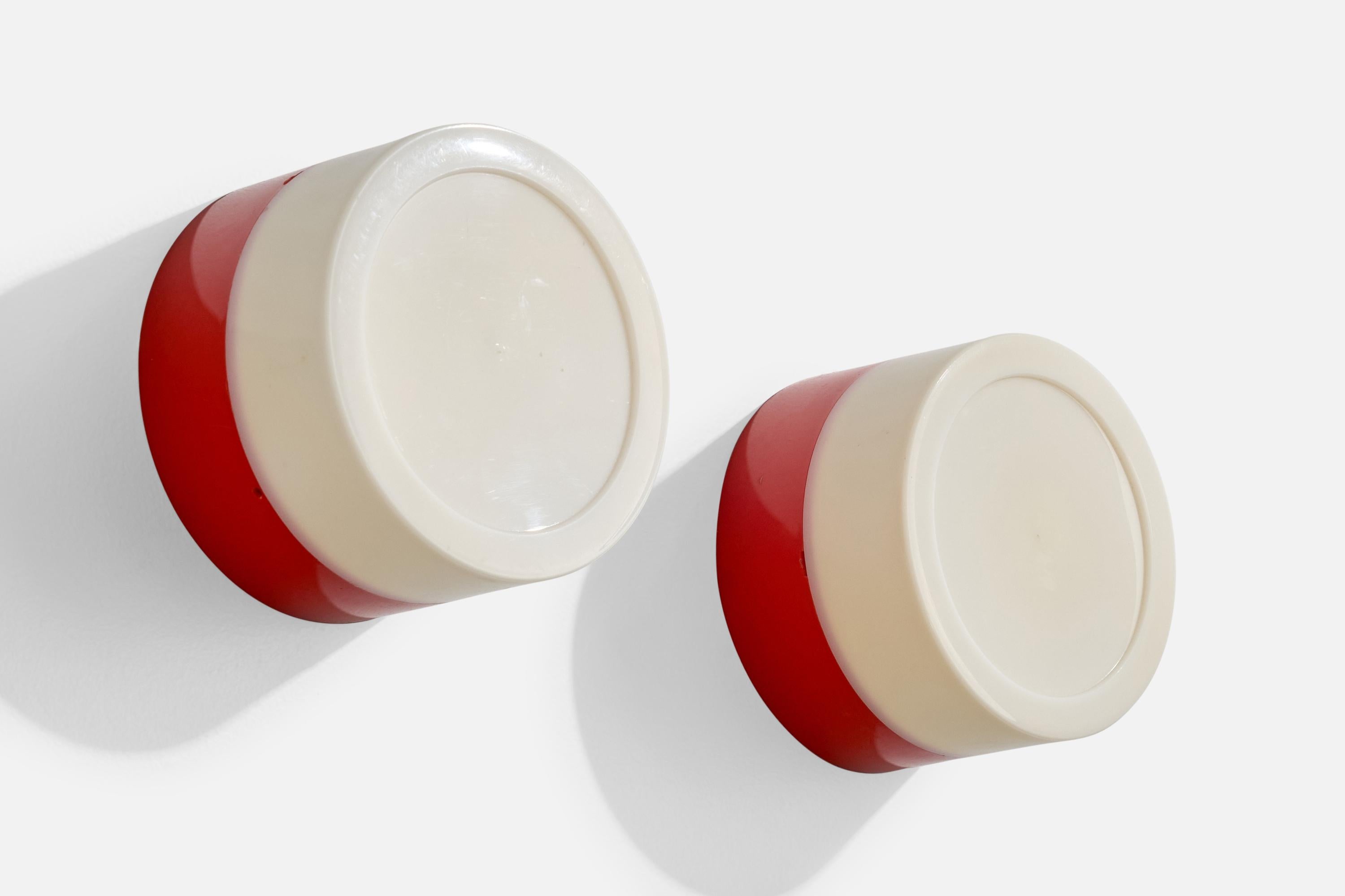 A pair of red and white plastic wall lights or flush mounts produced by Fagerhults Belysning, Sweden, c. 1970s.

Overall Dimensions (Inches): 7.4” Diameter x 4.625” D

Bulb Specifications: E-26

Number of Sockets (per fixture): 1

Does not include