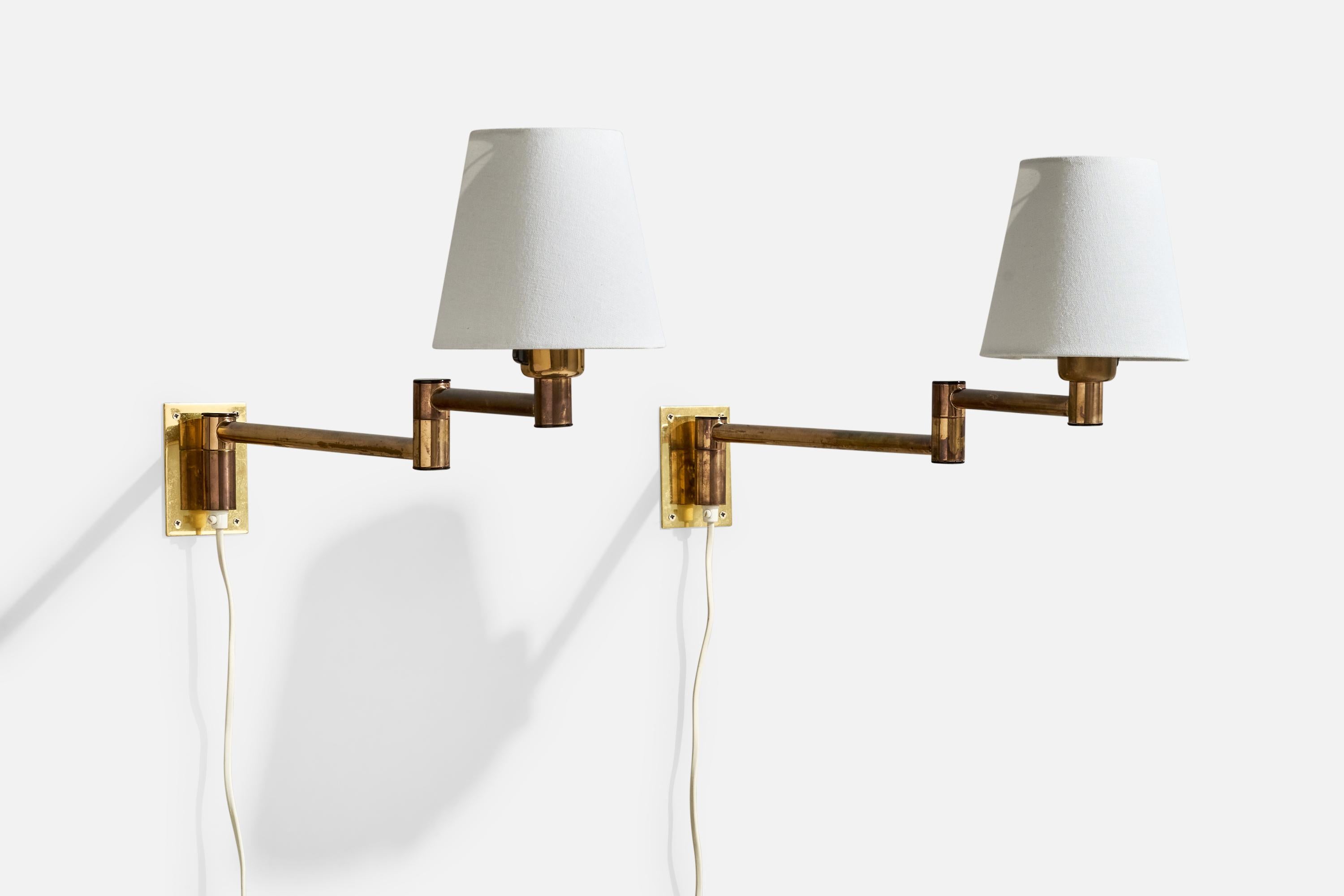 A pair of adjustable brass and white fabric wall lights produced by Fagerhults, Sweden, c. 1980s.

Overall Dimensions (Inches): 12.5” H x 6” W x 20.4“ D (measured fully extended)

Back Plate Dimensions (Inches): 3.9” H x 2.8“ W x .05” D

Bulb