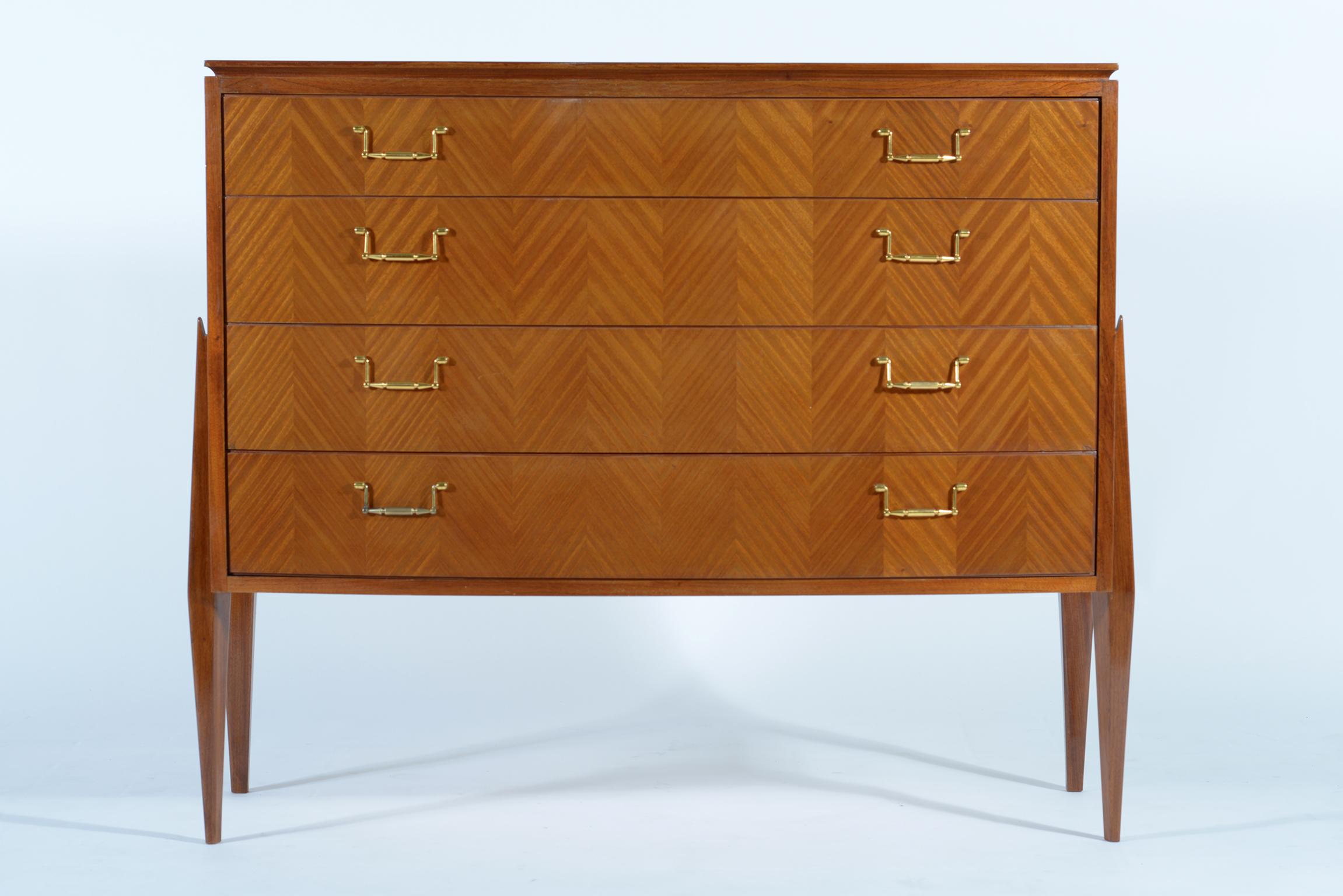 Four drawers midcentury chest made in Florence Italy by Fagioli in the late 1940s, convex front, pretty shaped slender detached legs sculptured in solid wood that sustain the body. Cast brass handles.
 