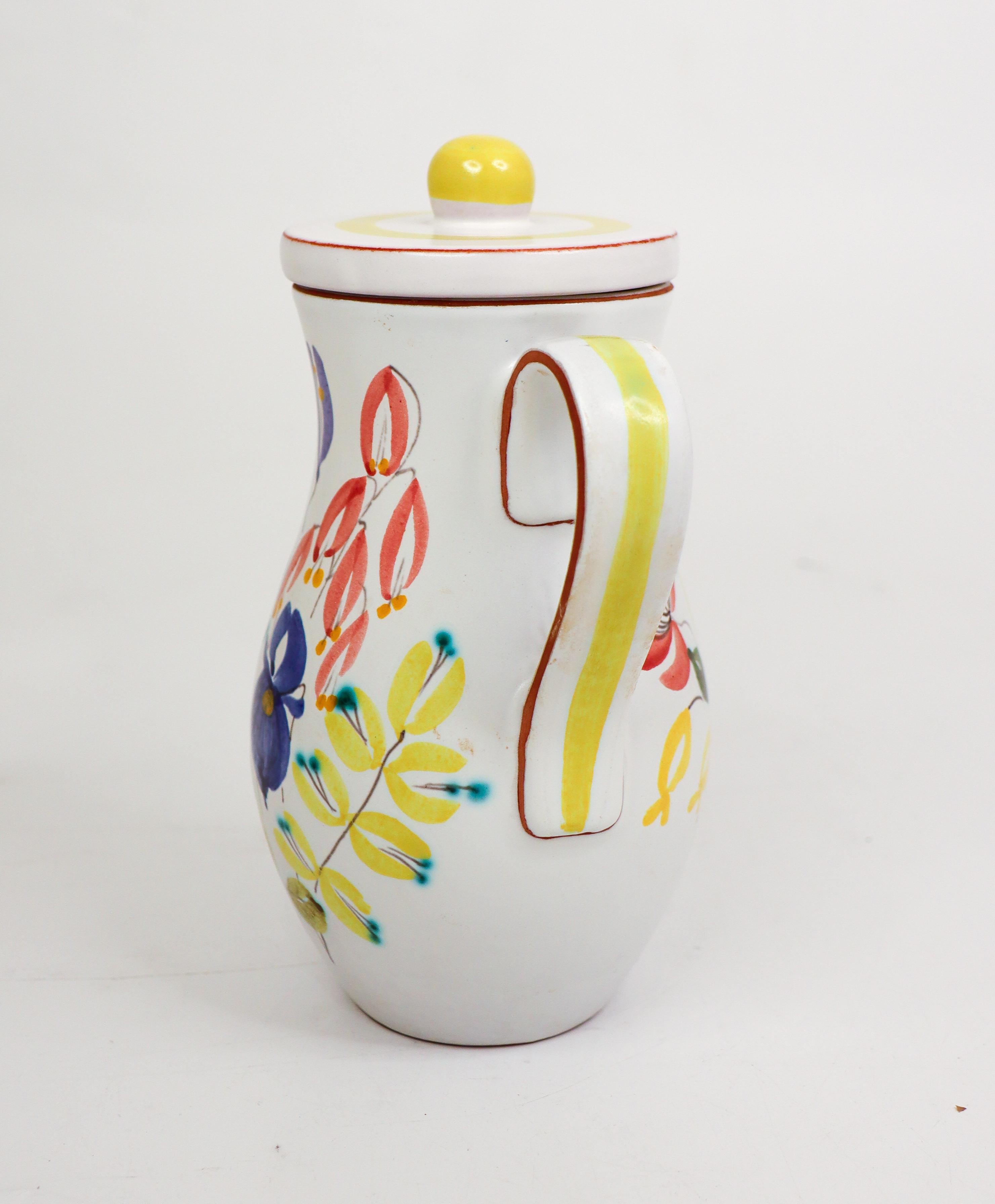 A lovely and rare jug with lid in faience designed by Stig Lindberg at Gustavsberg in the 1950s. The jug is 17,5 cm high and in excellent condition. It is marked below. 

In 1942, Gustavsberg opened the exhibition 