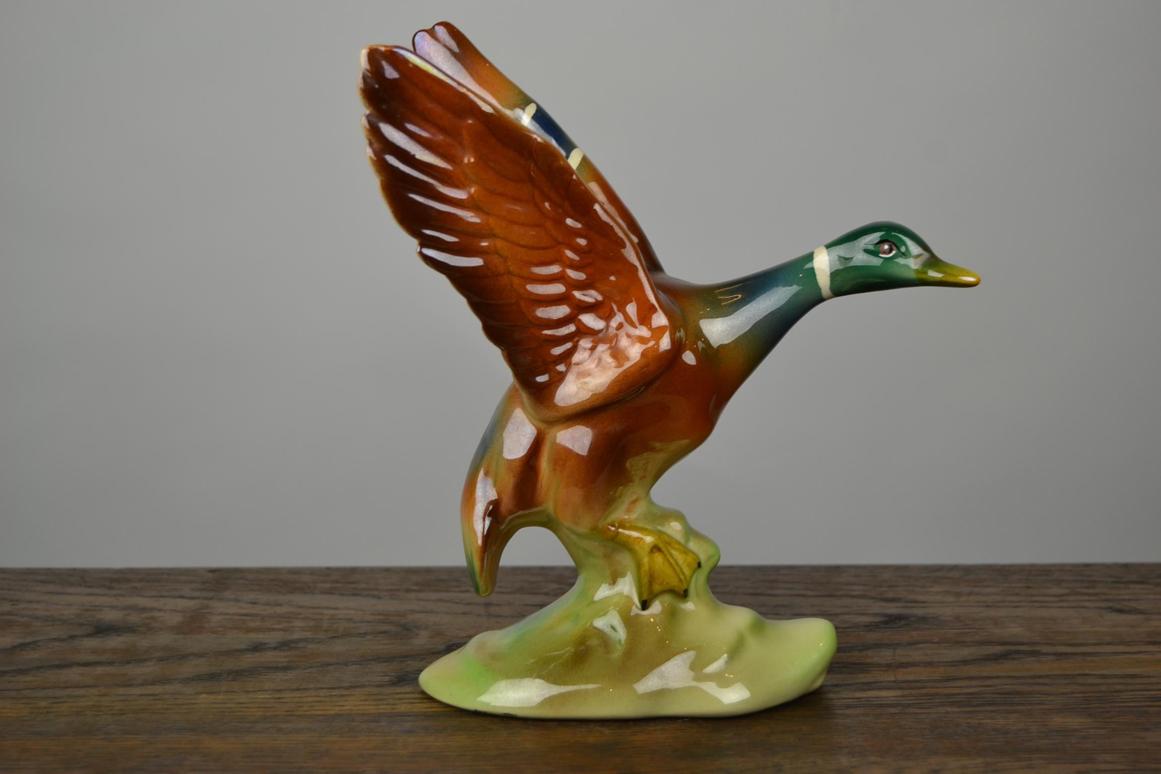 Vintage handmade ceramic, pottery duck figurine, duck statue. 
The duck is spreading her Wings to fly away. 
Beautiful colored bird figurine, water bird, animal sculpture, circa 1950-1960
Numbered and signed on the bottom.