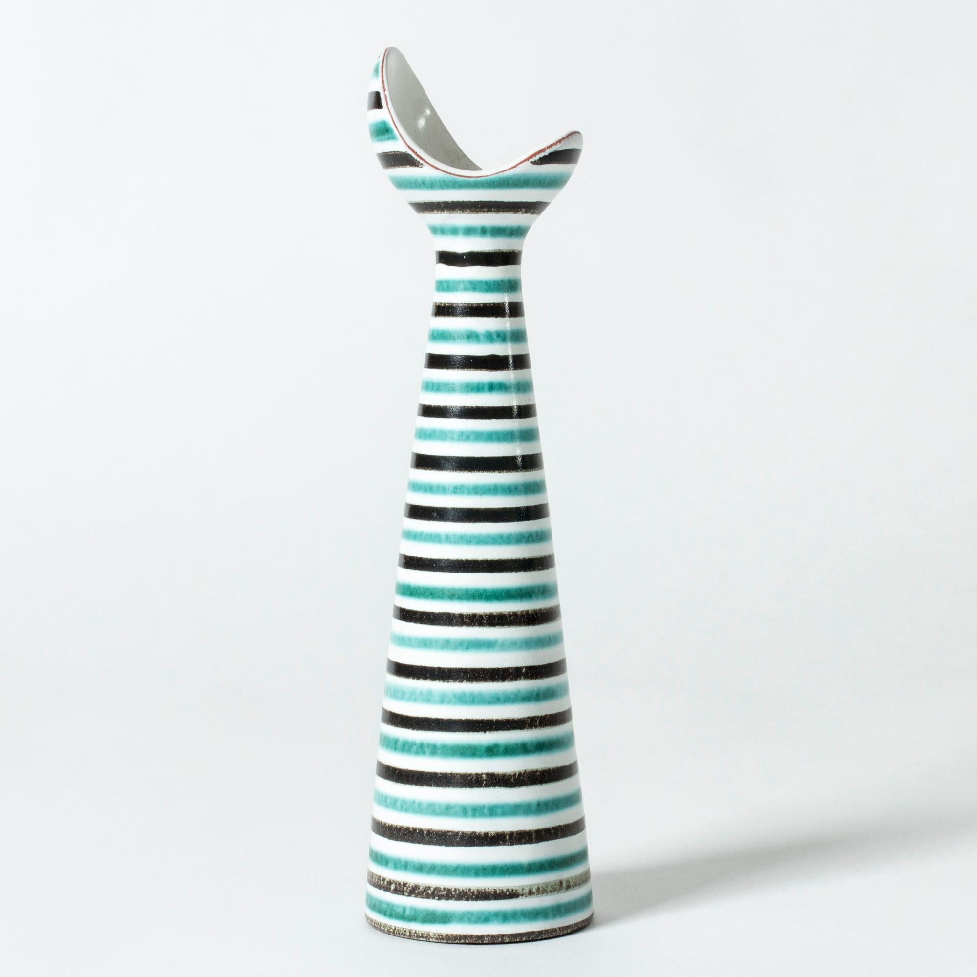 Cool faience vase by Stig Lindberg, in an asymmetrical, fun form. Graphic, hand-painted pattern of black and aquamarine stripes.