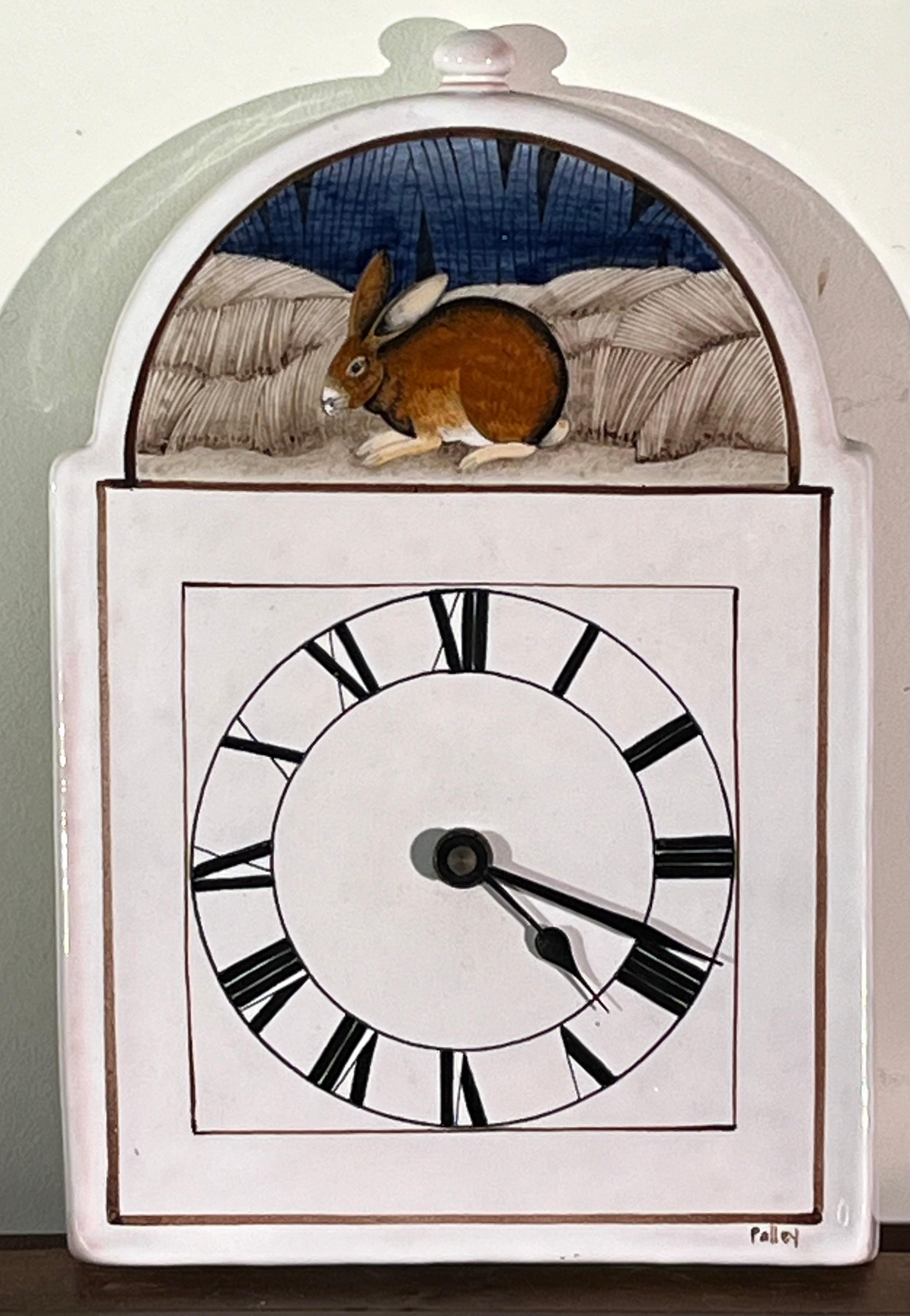 A charming wall clock in hand-painted faience, by Claude (1927-2008) and Slavik (1920-2005) Palley. The Palleys created their pieces in Ivy-Sur-Seine France and were exclusively represented by Pierre Deux through the 70’s and 80’s. 