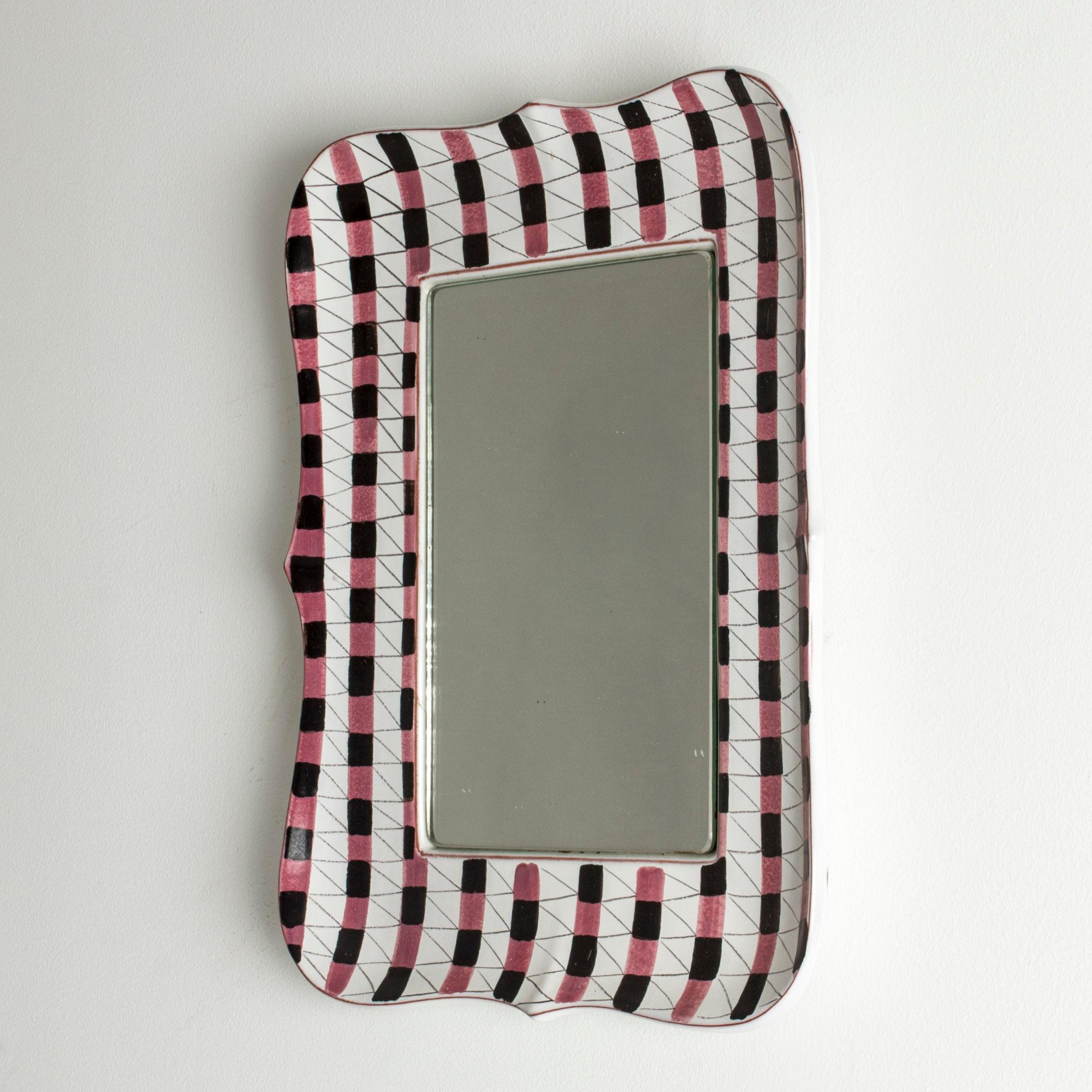 Faience wall mirror by Stig Lindberg with a beautiful, vivacious checkered decor with pink and black stripes.