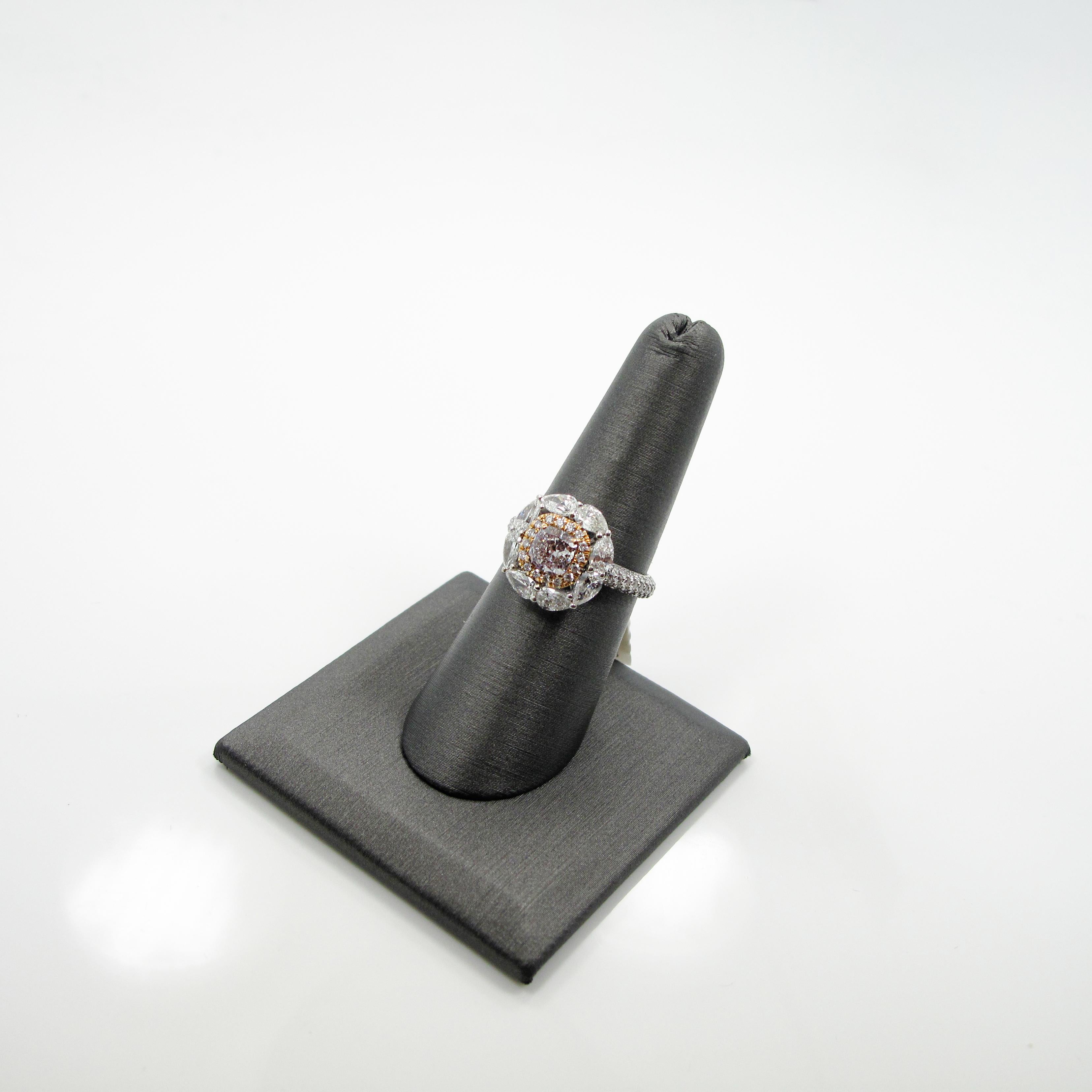 One 18k white gold and white and fancy diamond ring. The ring features a 1.00ct. faint pink cushion modified brilliant which measures 5.54x5.52x3.87mm and is accompanied by GIA certificate # 6197904266.  The diamond is set in an 18k rose gold basket