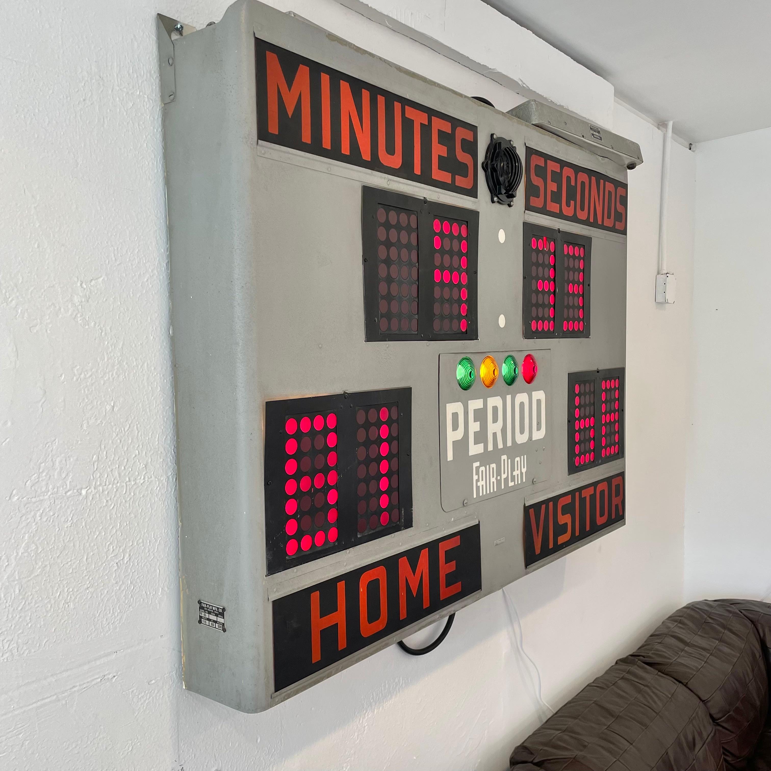 Vintage basketball scoreboard by Fair Play, made in the 1960s. Taken down from the Michigan Department of Military Affairs gymnasium. In full working order with controller to adjust score, running shot clock, and working horn. Matte grey case in