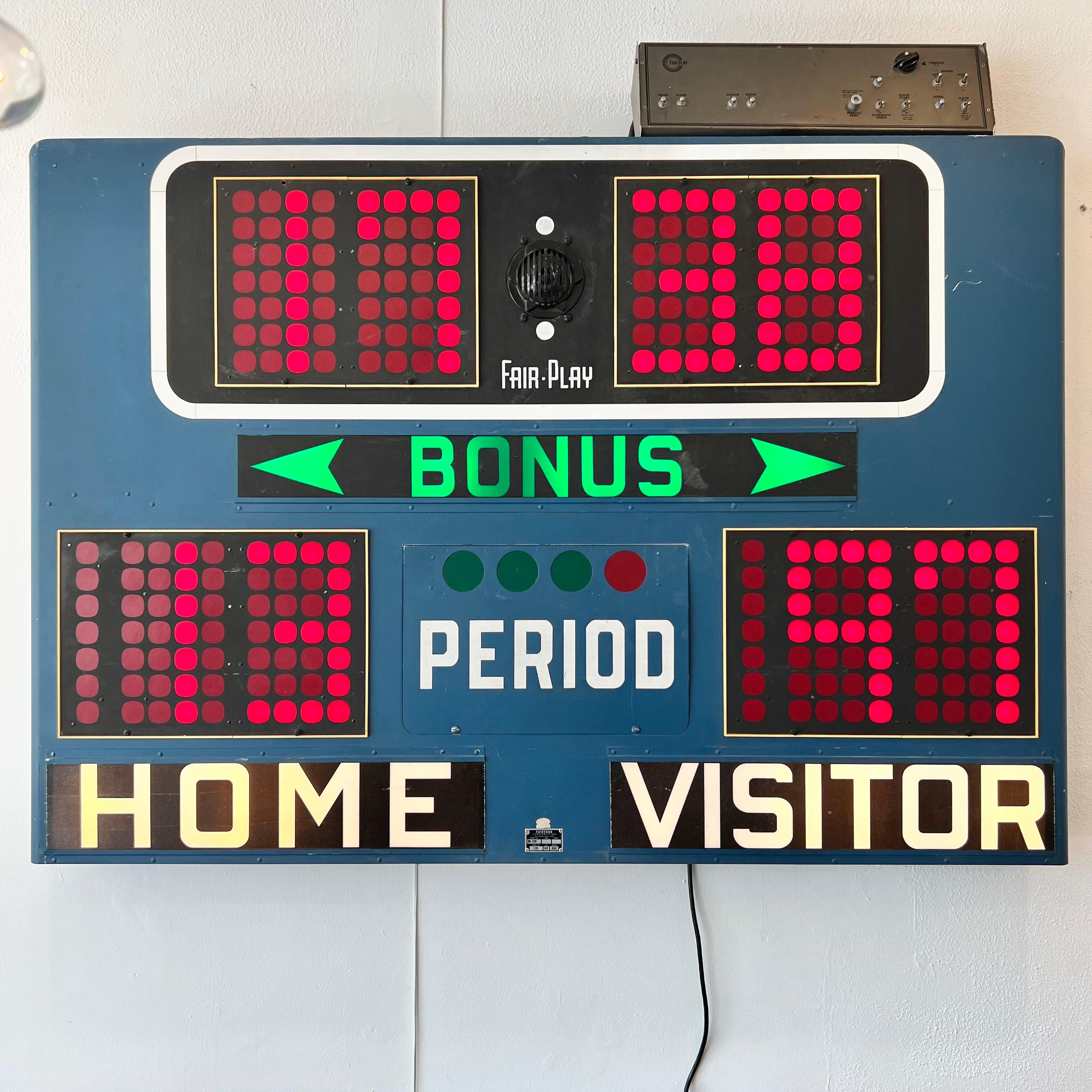 Vintage basketball scoreboard by Fair Play, made in the 1960s. Taken down from a high-school in Ohio. In full working order with controller to adjust score, running shot clock, and working horn. Blue case in great condition with minimal wear.