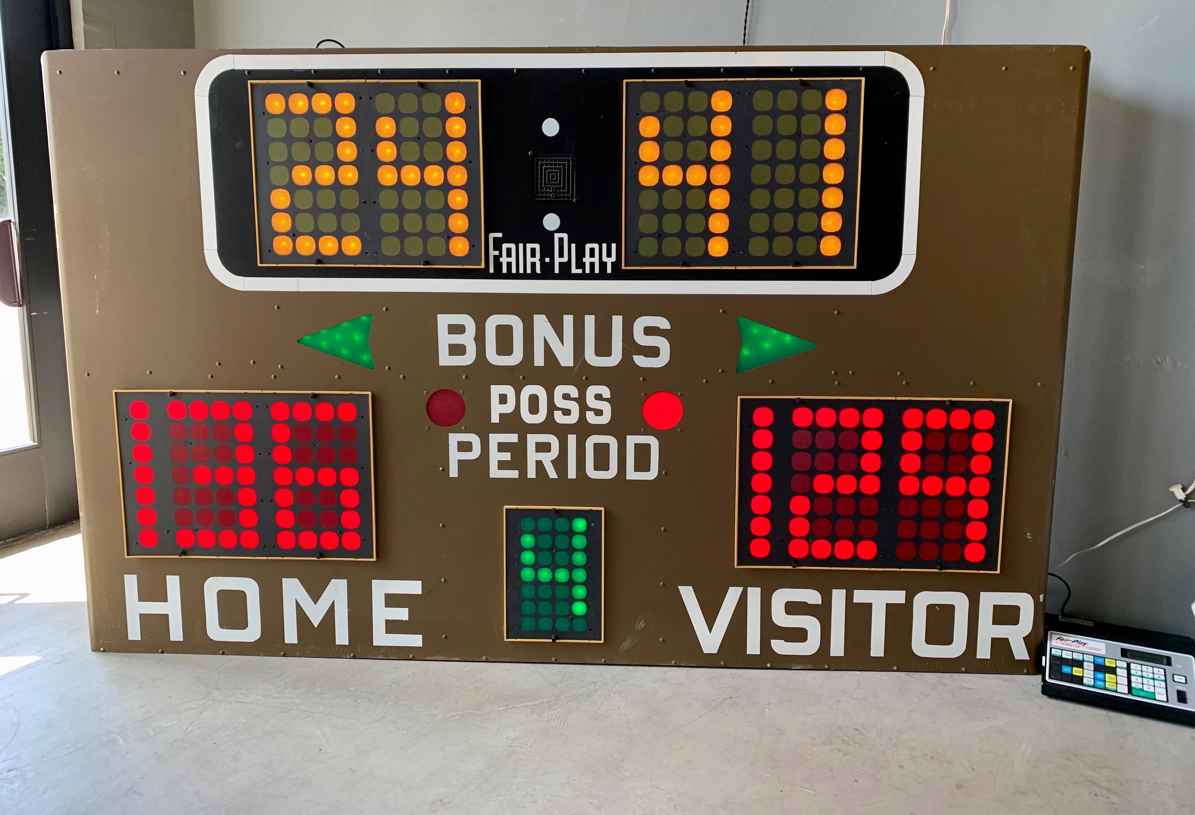 Great vintage basketball scoreboard by Fair Play, made in the 1970s. In perfect working order with controller to adjust score, running shot clock etc. Working Horn. Very fun piece of art for your home or commercial space. Taken down from a school