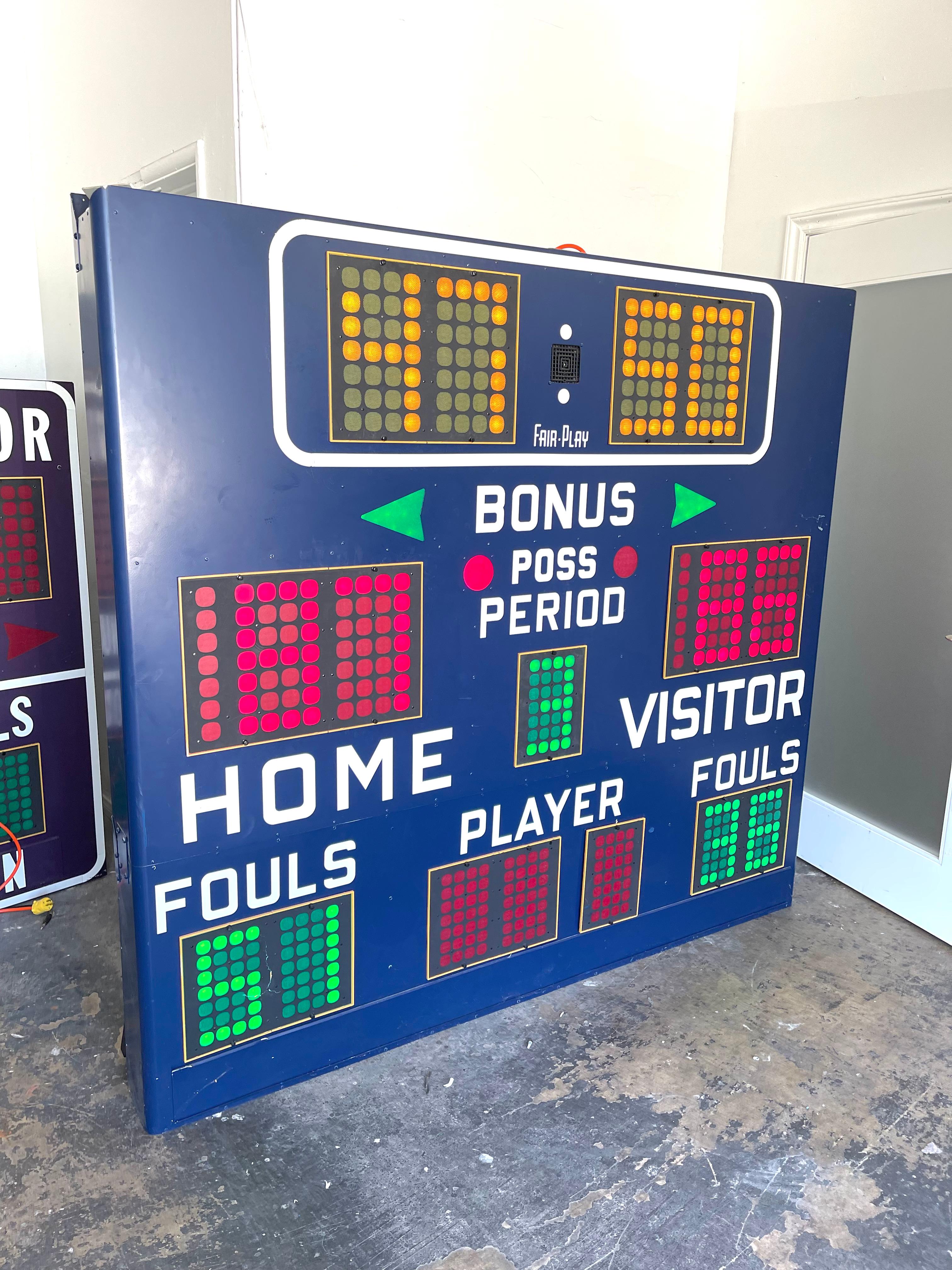 Vintage basketball scoreboards by Fair Play, made in the 1970s. In full working order with controller to adjust score, running shot clock, and working horn. Cobalt blue case in good condition with minimal wear. Fun piece of art for your home or
