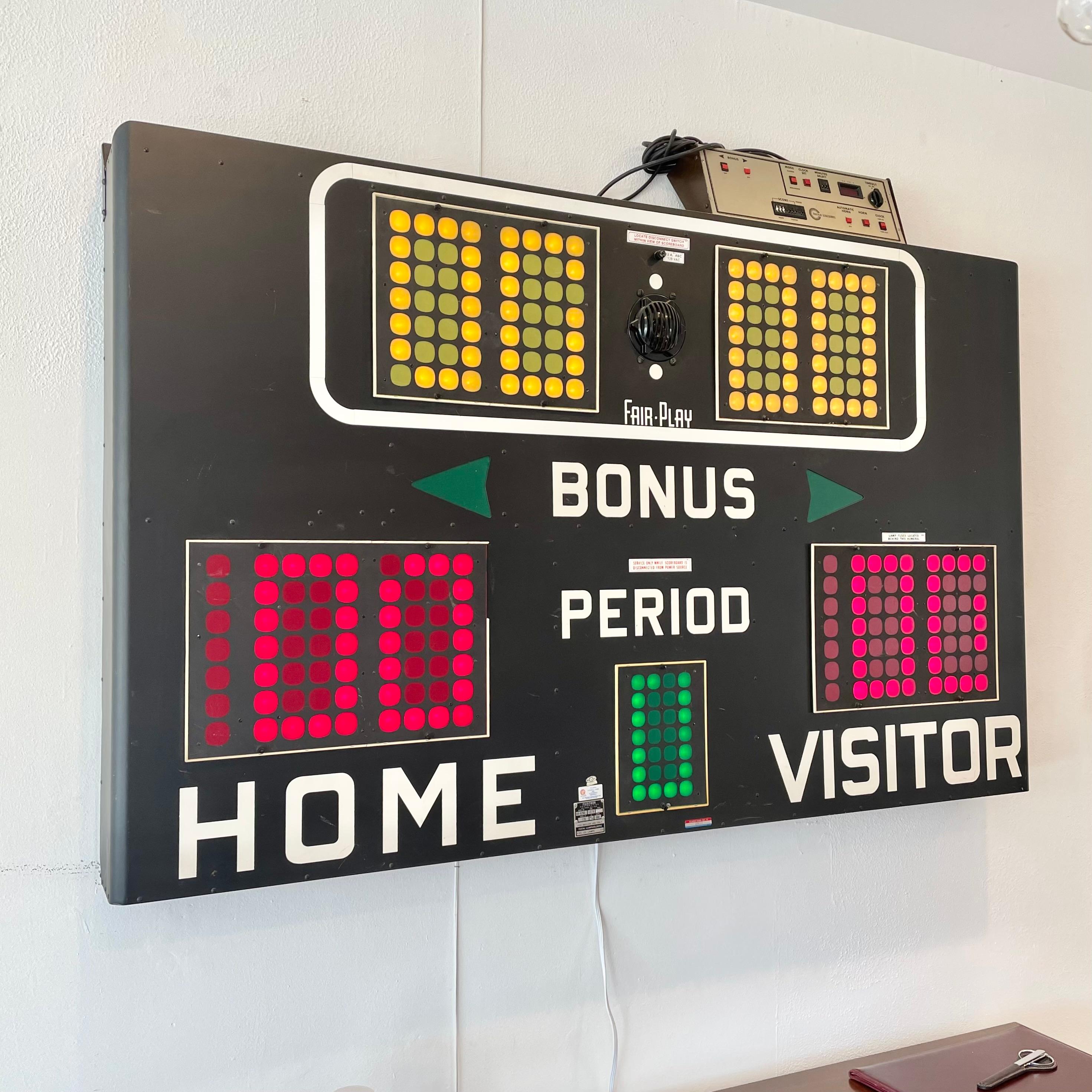 Great vintage basketball scoreboard by Fair-Play, made in the 1970s. In perfect working order with controller to adjust score, running shot clock etc. and working horn. Very fun piece of art for your home or commercial space. Removed from a school