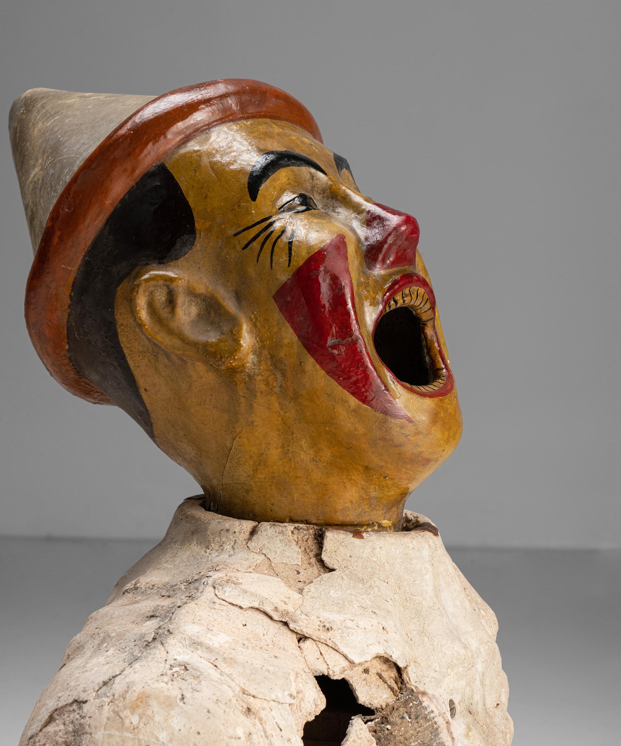 Fairground ball-toss game 

England Circa 1910

Laughing clown in painted plaster and hessian with cast iron inner piping.

Measures: 22.5” W x 9.25” D x 26.5” H.