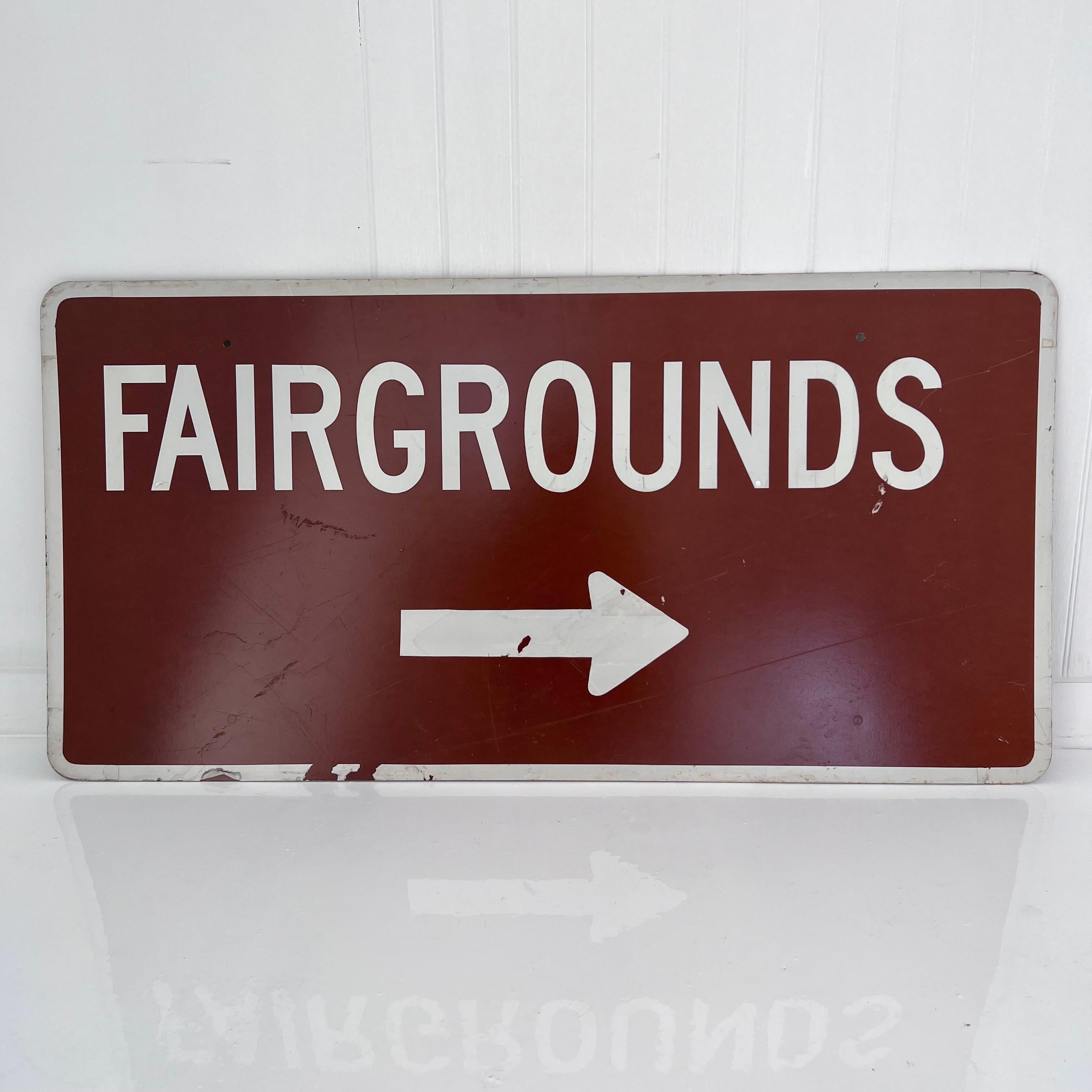 Vintage 1980s Fairgrounds sign in a unique and bold oxblood base color with white font. Eye catching and fun, this piece has the trappings of Americana wall art. Slight scuffs and scratches on the sign only add to its unique antique feel. An item