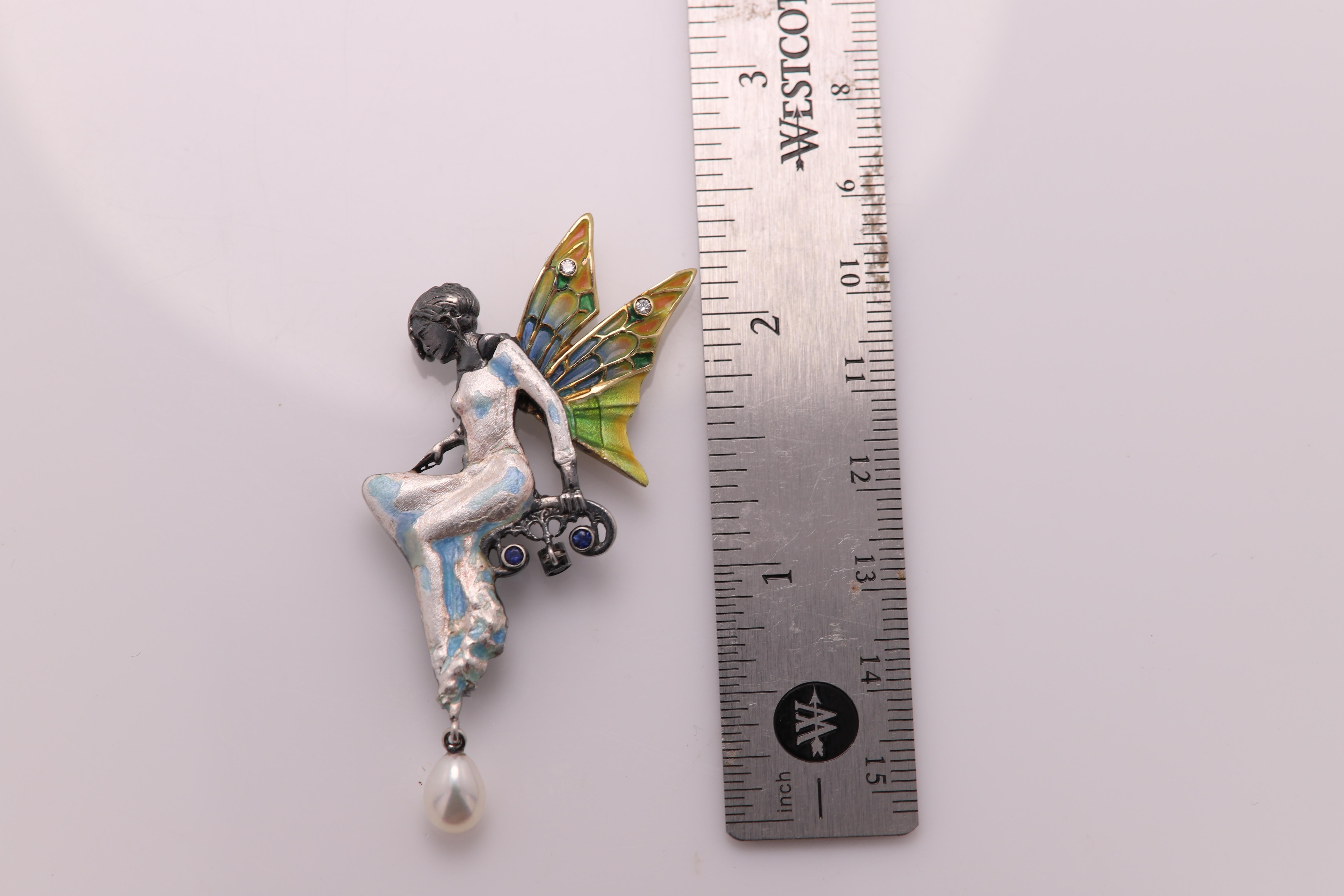 Vintage Hand made in Spain Enamel - Necklace  Brooch Pin
Sterling Silver and 18K Yellow Gold with brilliant Enamel colors
approx size 2.5'  inch long (65 mm)
few Diamonds and Blue sapphire 
Total Weight 10.3 grams
Dangling pearl on the bottom
Style