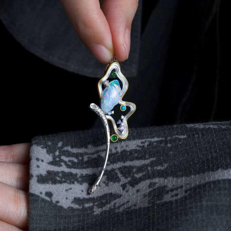 Fairy Whisper - Fire Opal Necklace in 18K White Gold with Diamonds, Sapphires & Turquoise.



Design name: Fairy Whisper

Design idea: This enchanting 18K White Gold pendant features a mystical fire opal, framed by fluid, fairy-like curves. Adorned