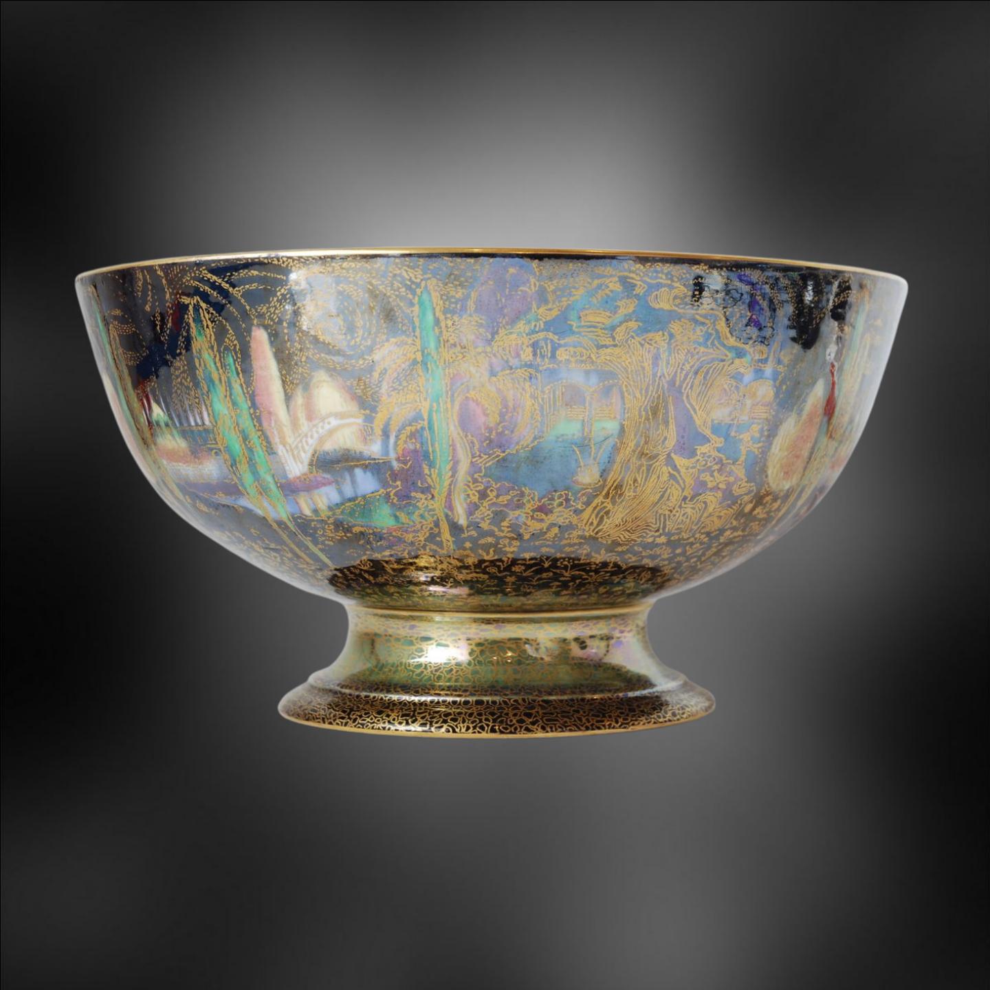 An extraordinary example of Fairyland Lustre, in the form of a punch bowl, decorated with Poplar Trees and Woodland Bridge patterns. A substantial and impressive piece, in unusually good condition.

Signed MJ for Makeig-Jones. The monogram is