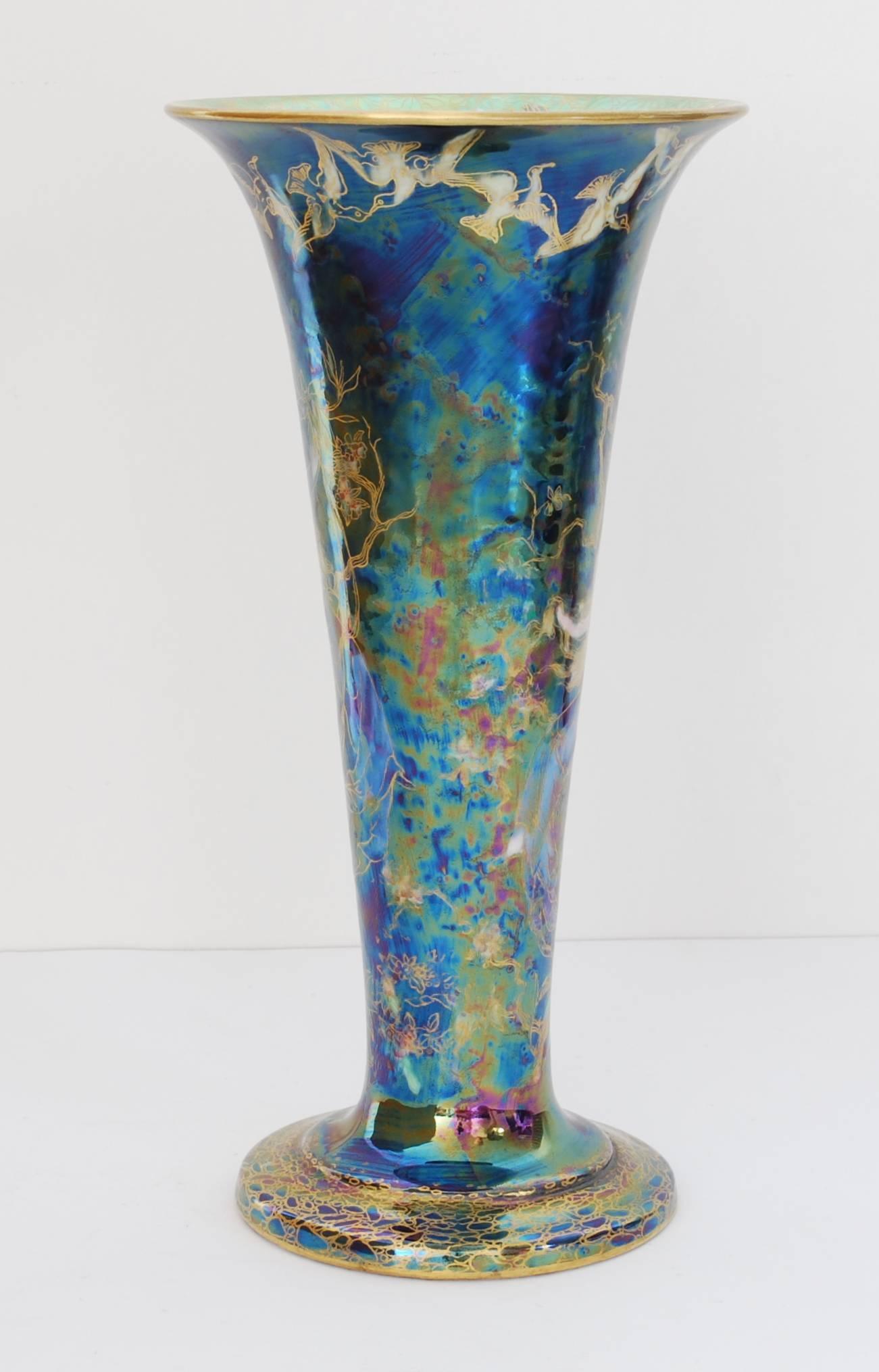 A trumpet-shaped vase in black Fairyland lustre, decorated with the butterfly ladies pattern.

At 10”, this is the largest of the three sizes in which this vase was produced.