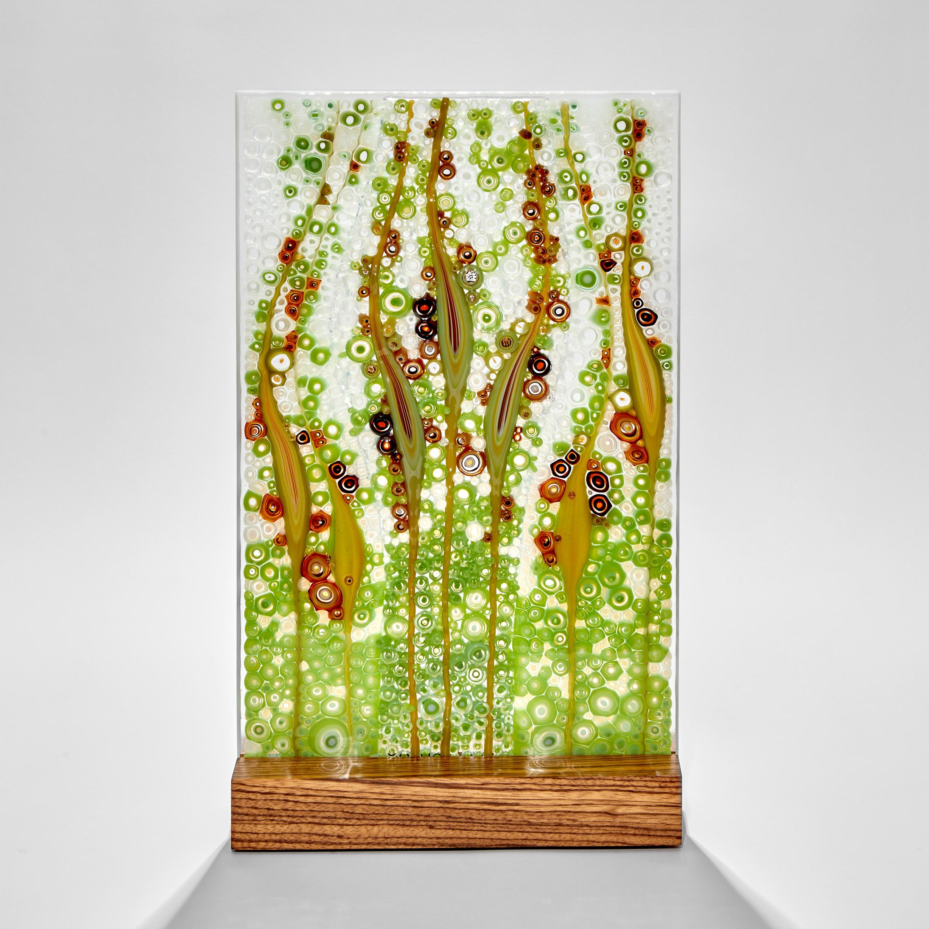 'Fairytales & Legends', is a unique green, red and white glass sculpture with zebrano wood base by the Austrian artist Sandra A. Fuchs. Fuchs creates her own multicolored and complex glass canes, which are then cut to create small 'murrina'. These