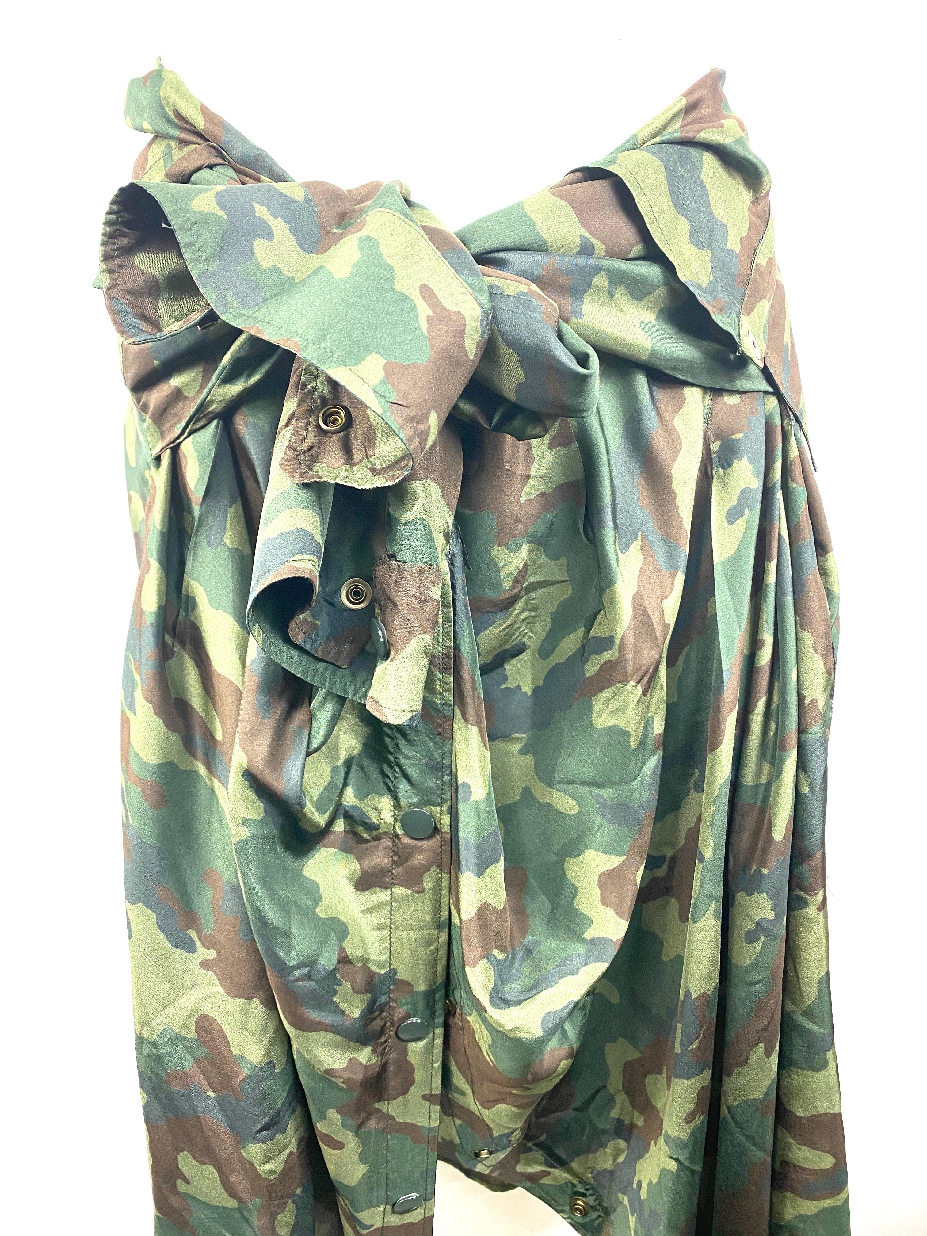 Product details:

Size Medium.
Featuring 100% silk, armi kiki, green camouflage print , button down shirt as a skirt design with imitated sleeves tie at the waist and front button down closure, mid length.
Made in Morocco.
