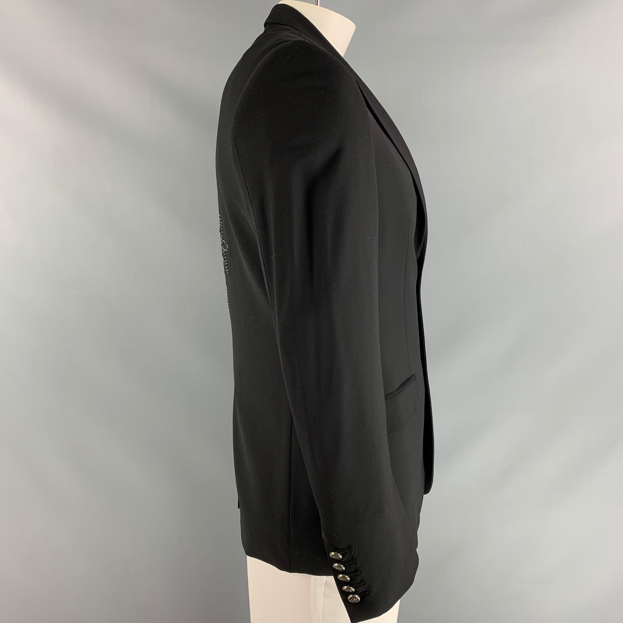 FAITH CONNEXION sport coat, fully lined comes in black fabric featuring two button closure, flap pockets, notch lapel and rhinestone applique at center back. Excellent Pre-Owned Condition. Fabric Tag Removed. 

Marked:   L 

Measurements: 
