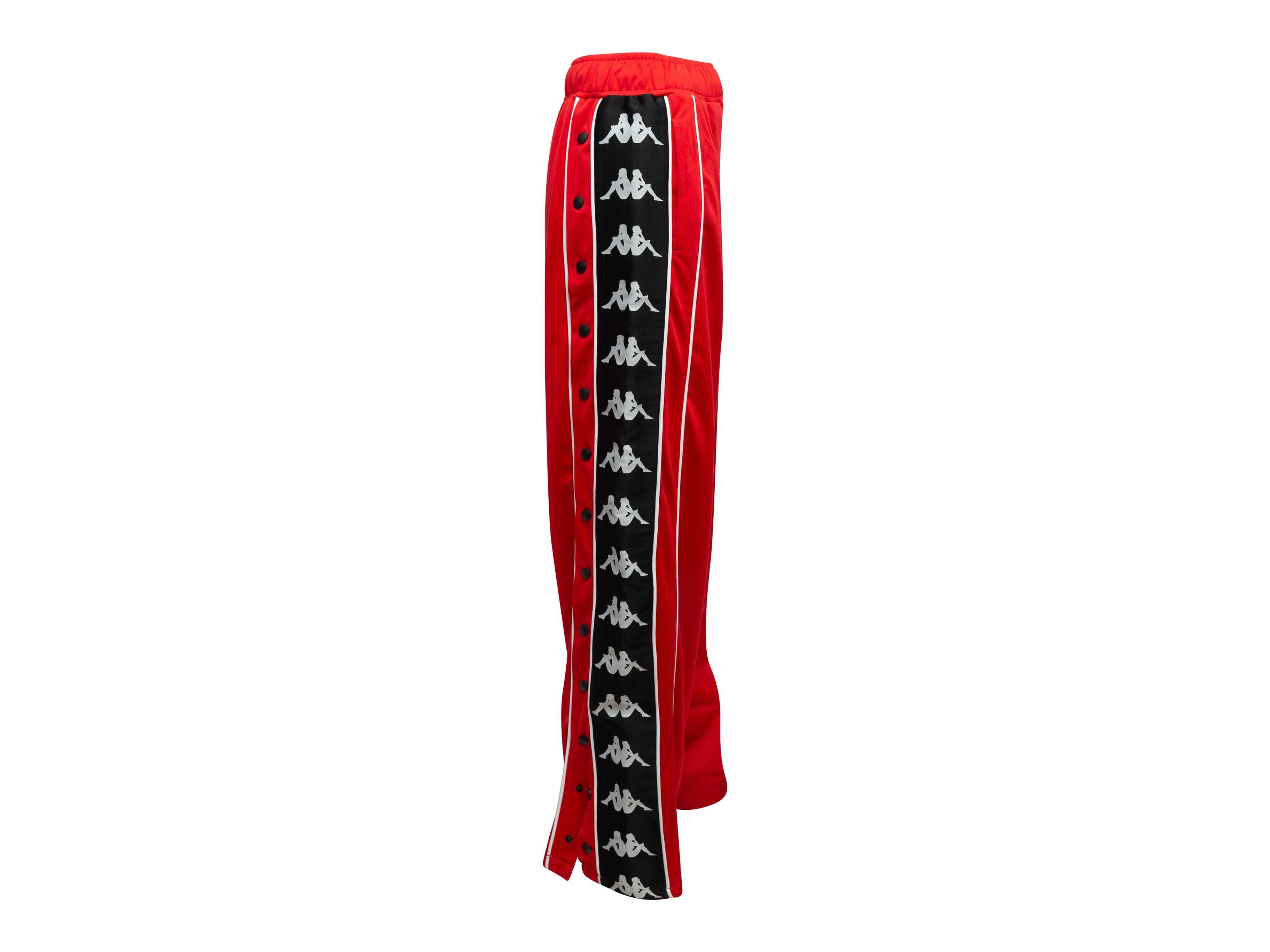 Product details: Red, black and white loose fit track pants by Faith Connexion x Kappa. Elasticized waist. Dual hip pockets. 27