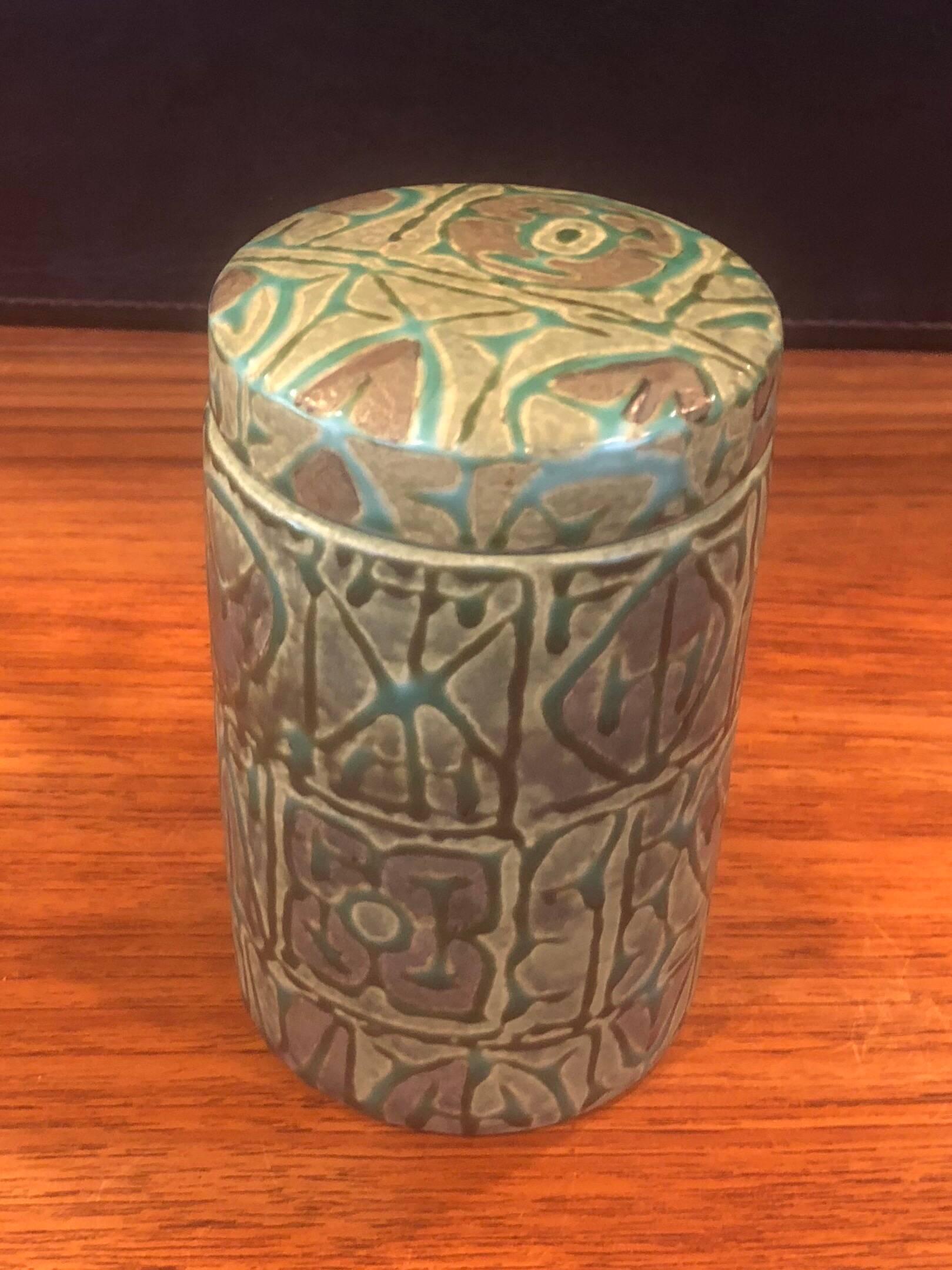 Fajance ceramic lidded jar / humidor from the Baca line by Nils Thorsson for Royal Copenhagen, circa 1960s. The green glazed stoneware jar with geometric abstract design in relief was designed by Royal Copenhagen's renowned artistic director, Nils